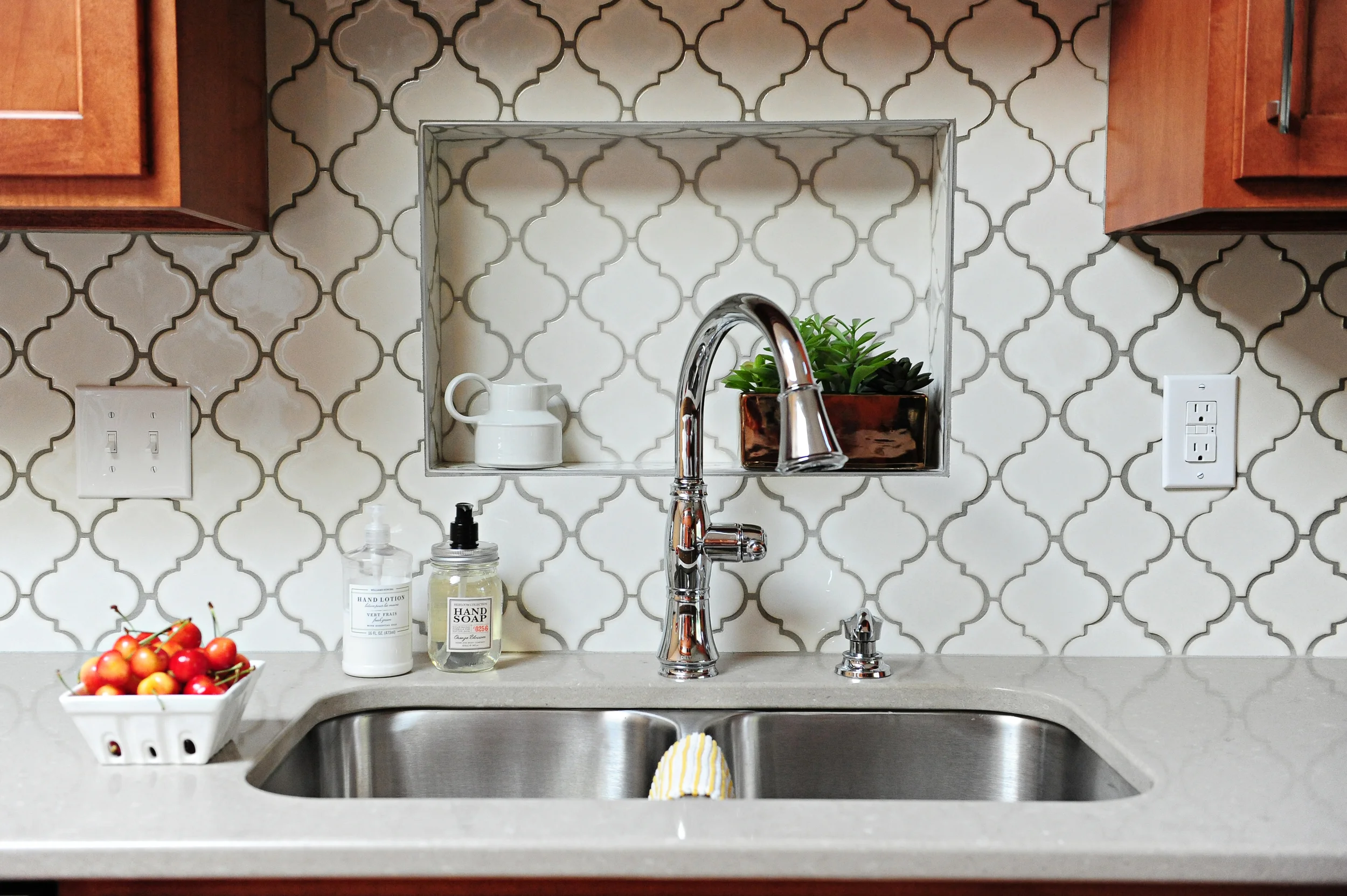 Backsplash: Metro Lantern Glossy White tile. Delta Cassidy faucet in Chrome.