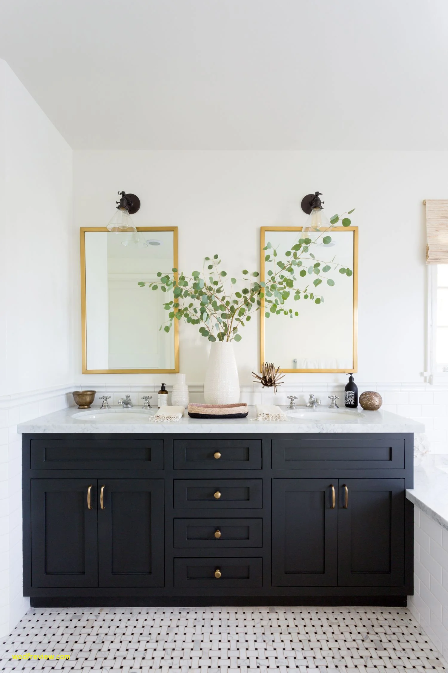 Yes. This one has three different finishes and it still works! The brass is grouped together in the handles and the complimented by the brass-framed mirror. The faucets are a timeless chrome. And the light fixtures are a bronze, which is pretty much a black and compliments the other metals. Photo used courtesy of JDP Interiors .