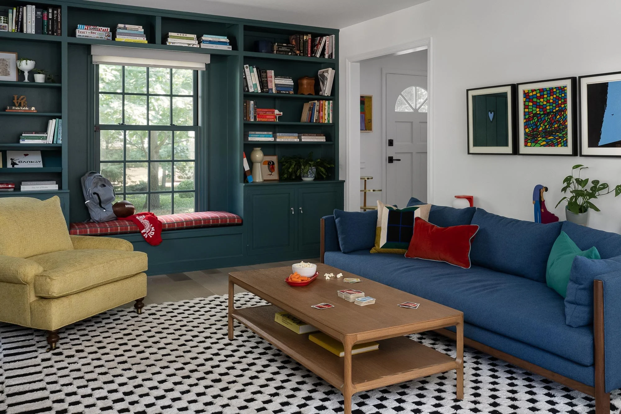 off-campus-canvas-blue-sofa-red-pillow-checkered-rug-yellow-chair.jpg