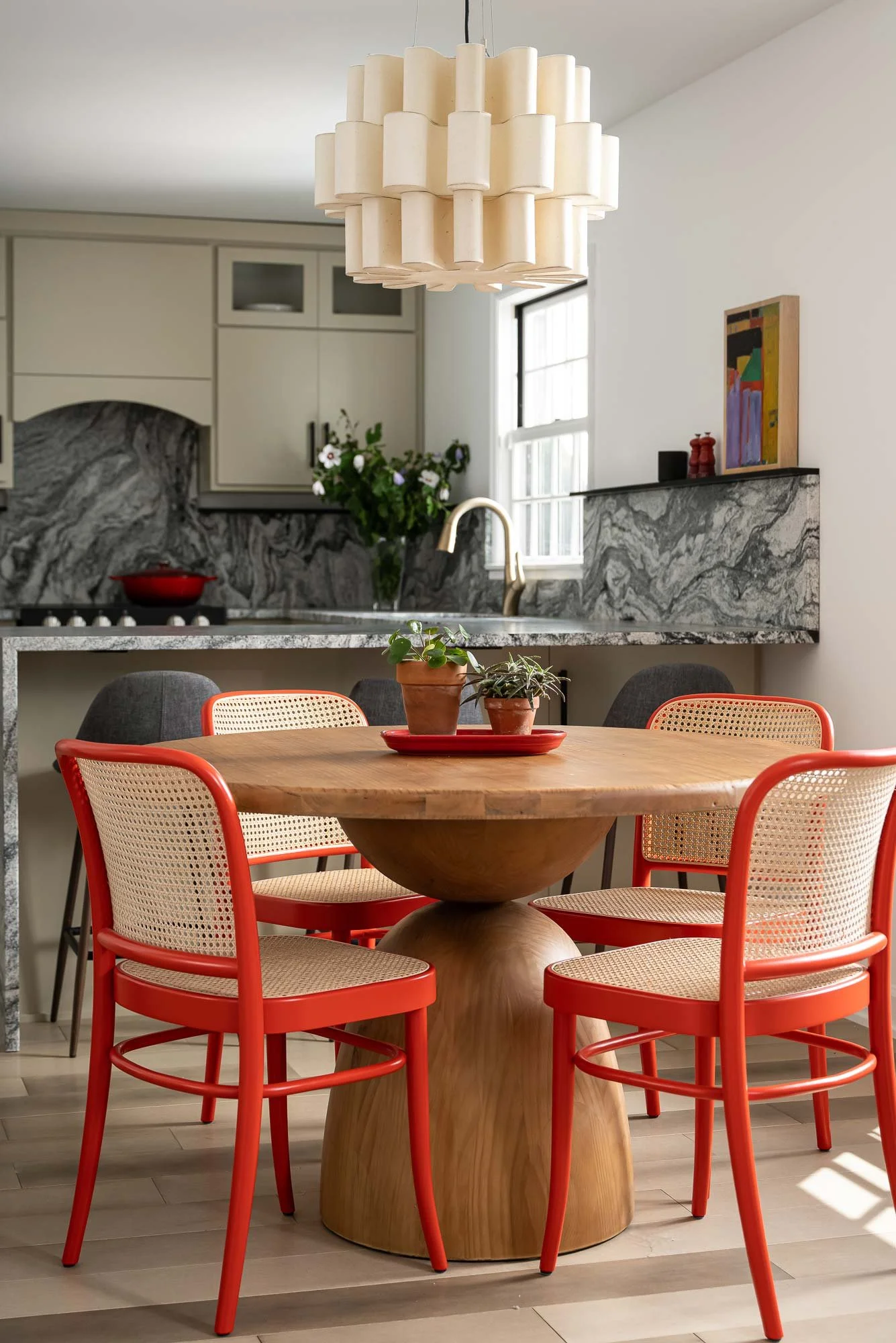 off-campus-canvas-kitchen-wood-table-light-fixture-orange-chair.jpg