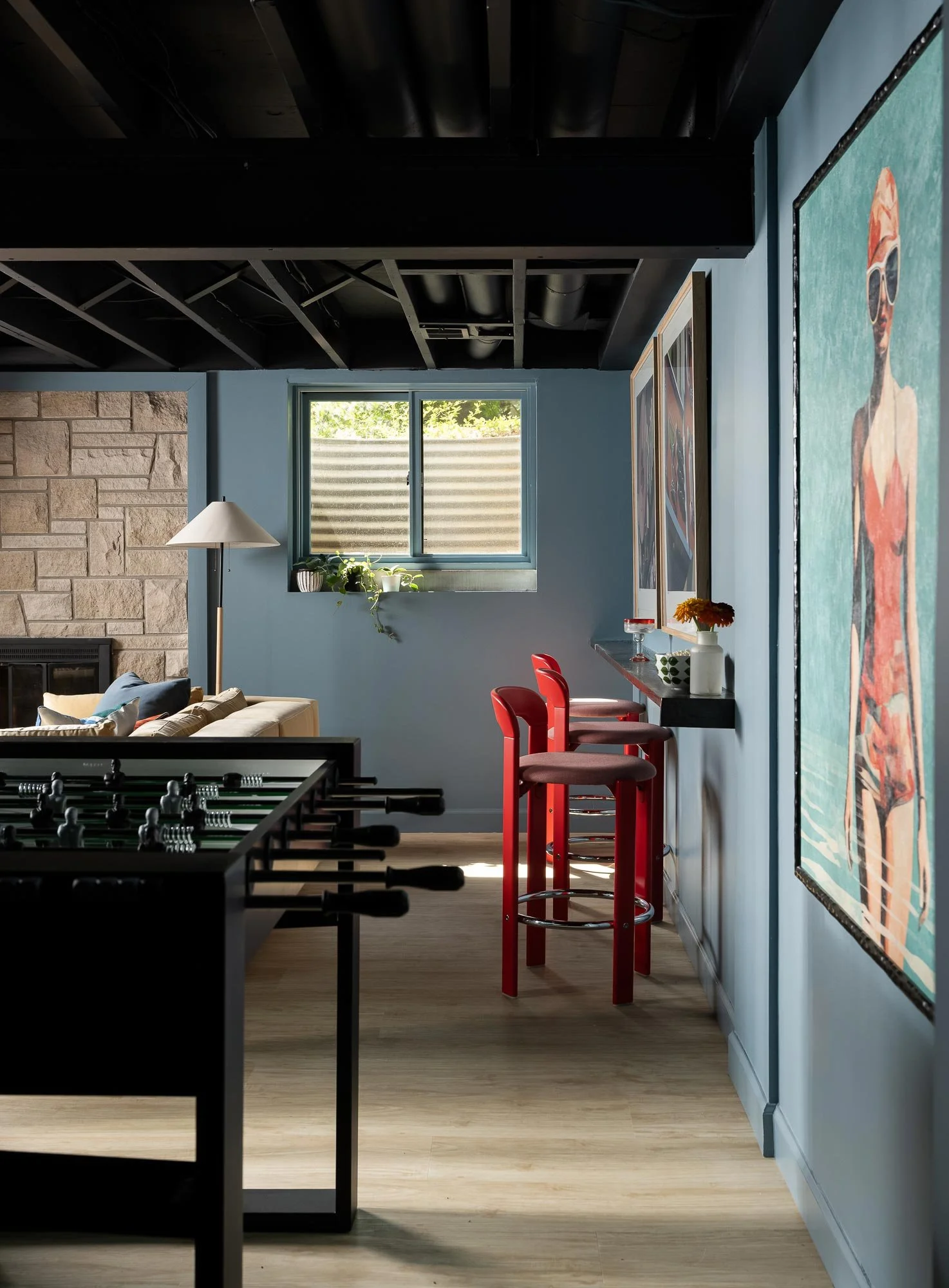 off-campus-canvas-basement-red-barstool-game-table.jpg
