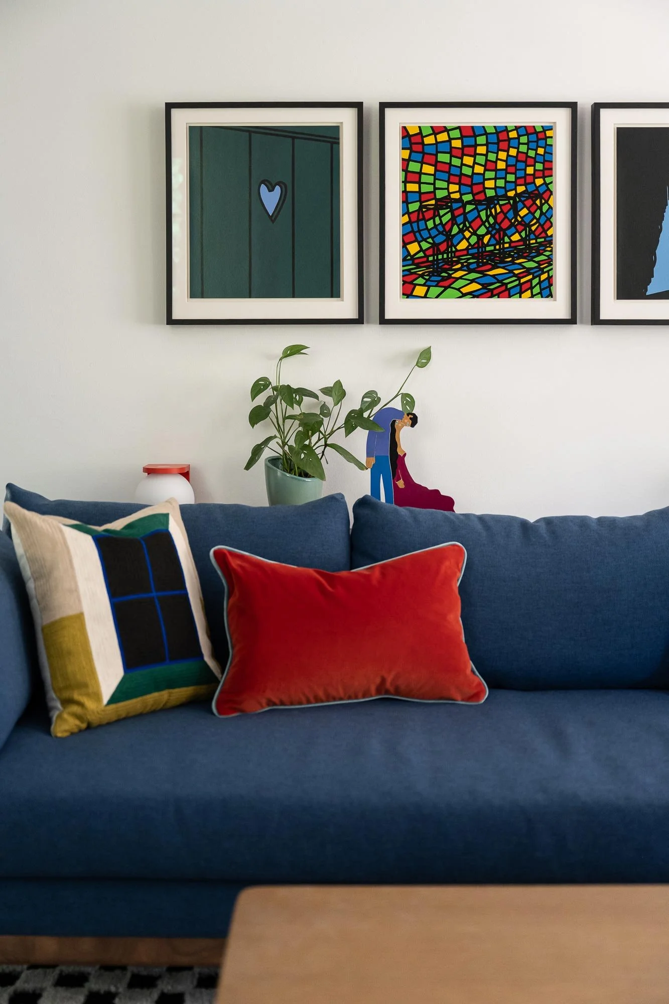 off-campus-canvas-living-room-chairs-sofa-art-blue-pillows.jpg