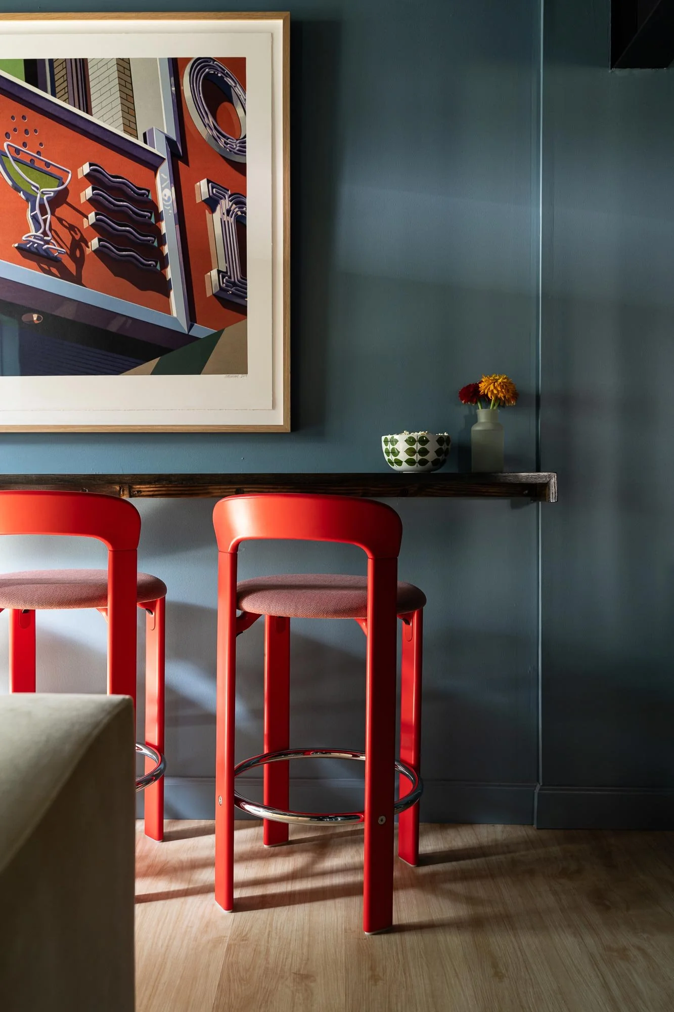 off-campus-canvas-basement-red-barstools-framed-art-deco.jpg