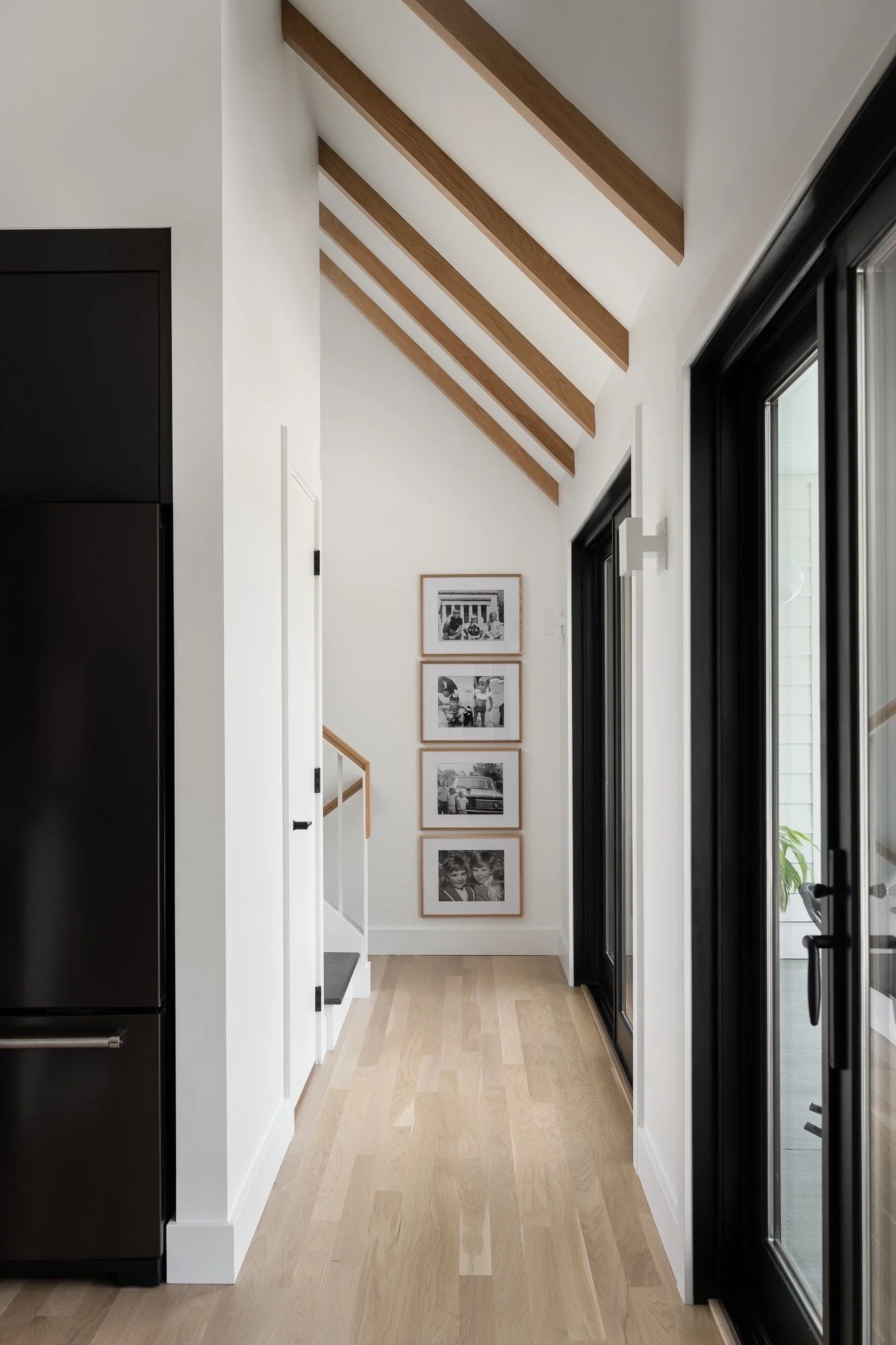 hallway-gallery-wall-exposed-beams-modern-farmhouse-interior-design-indiana.jpg
