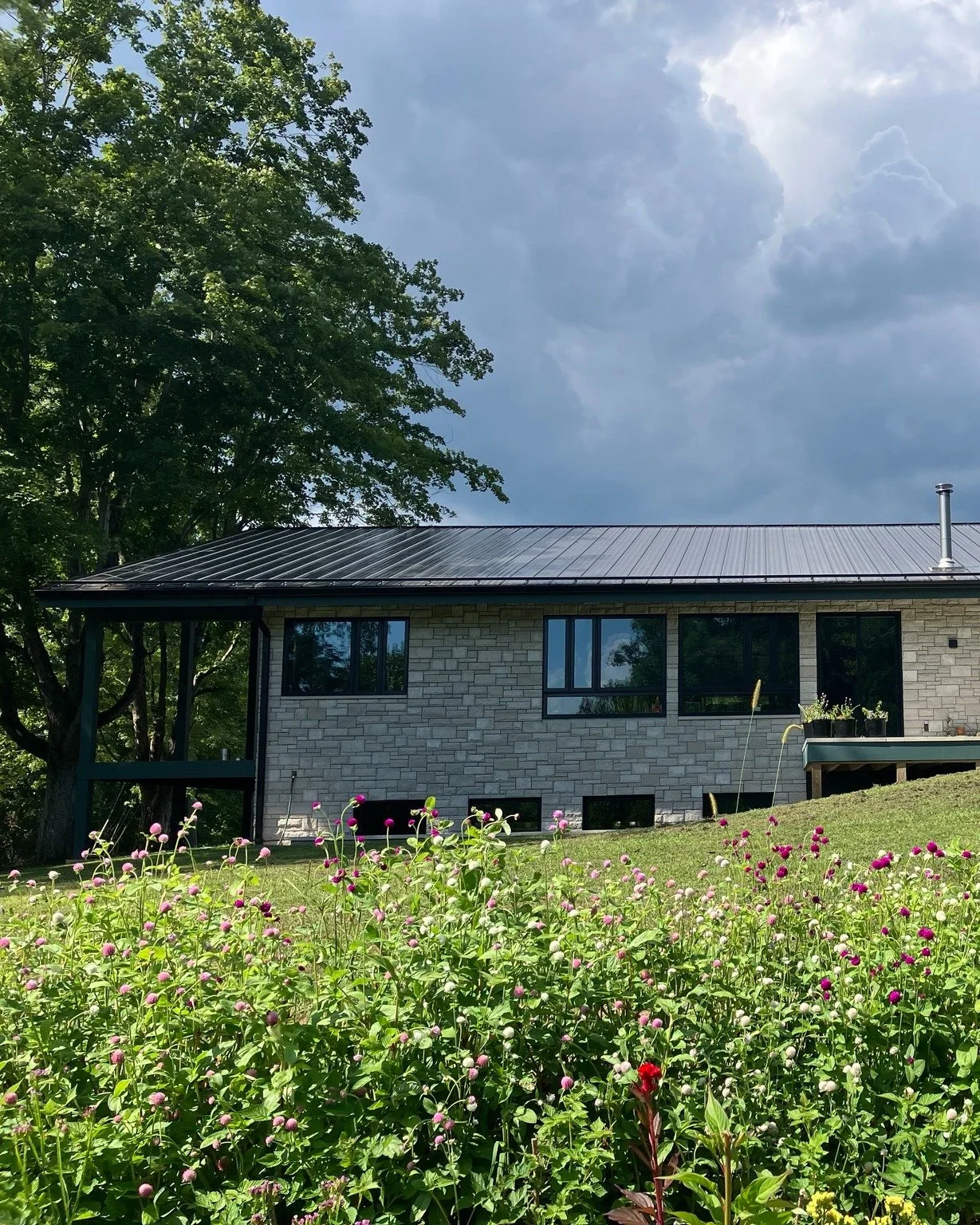 On a quiet little road east of town, this gem of a new build is finally fully dressed! We are hoping for a photo shoot in the Fall, but for now, sharing a little teaser of this happy home full of color, inside and out. Designed by our all-female home