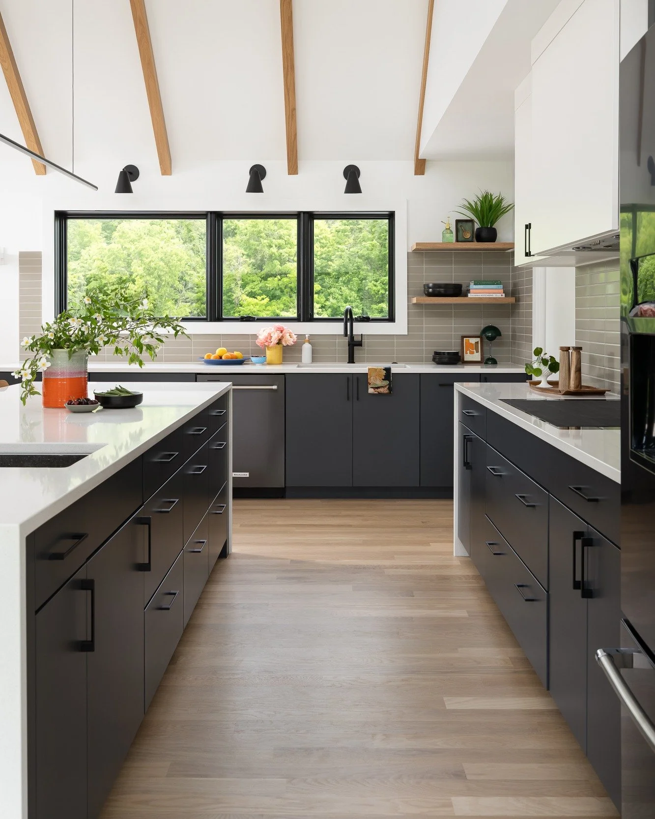 We challenge you: find us a home in which the kitchen is not the heart. But also: find us a home in which the flow and function of the kitchen is truly isolated from the rest of the public spaces. 

We're working on a new kitchen reno right now, for 