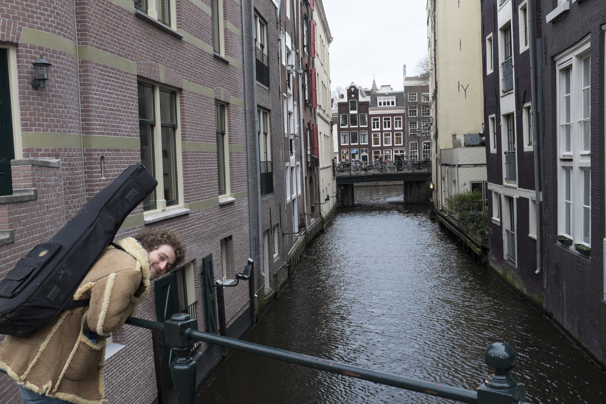 Asher and his guitar on a canal.