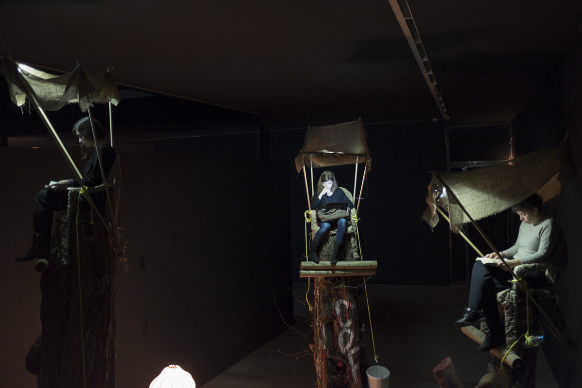 These folks are prescribed to sit on these high tree thingys throughout the run of the exhibition. 