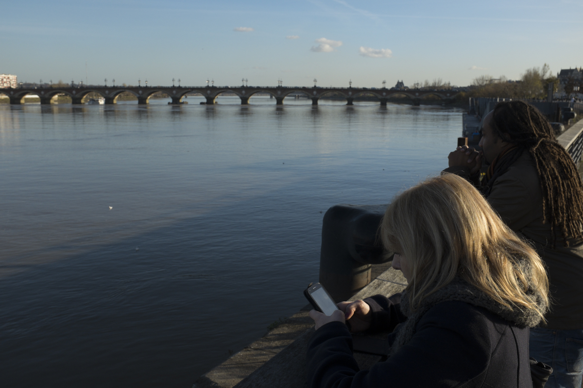 Standing along Pont de Pierre. Anaïs seems enthused.