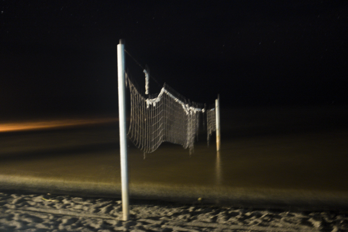 Creepy volleyball net at night.