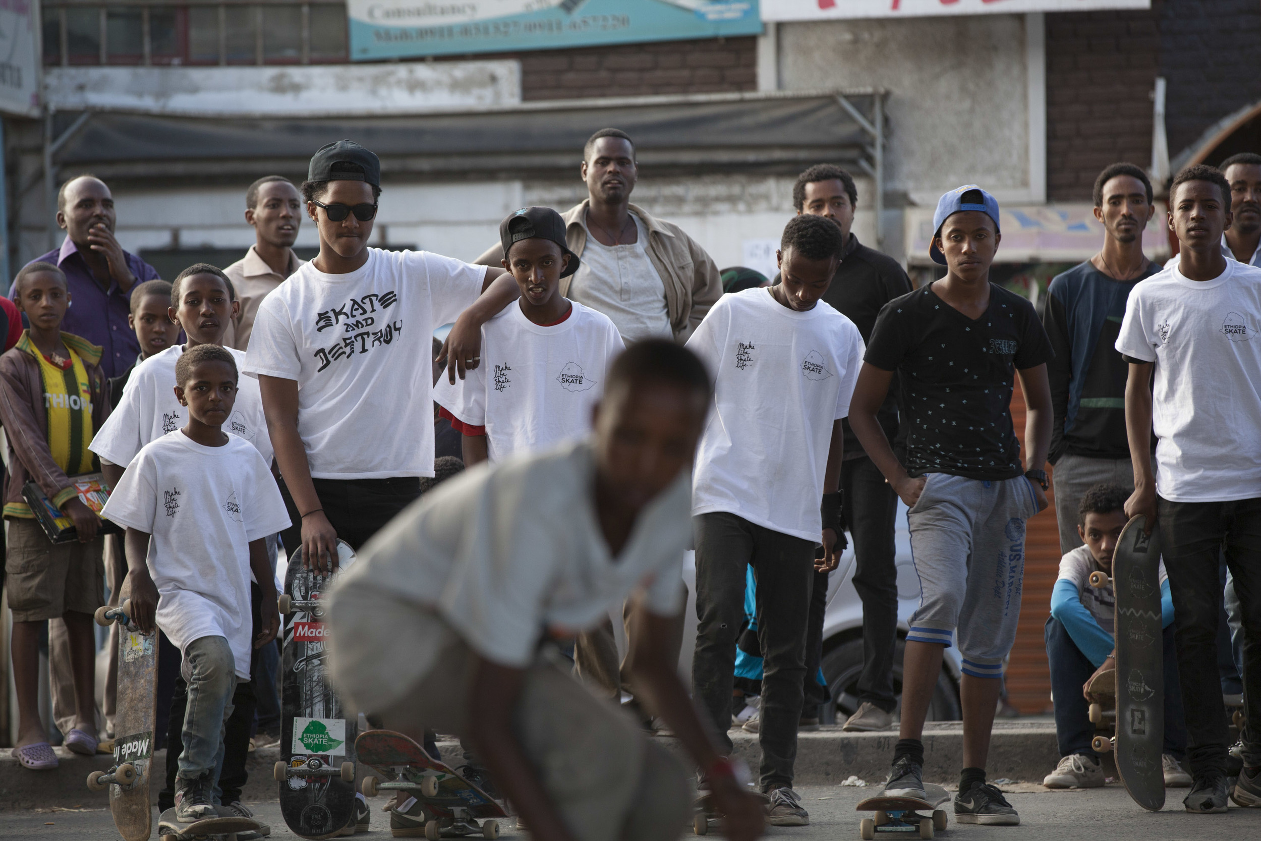  An young Ethiopian skateboarder, part of the Ethiopia Skate organization, is pictured mid-trick in the Bole area of Addis Ababa as his fellow skater friends watch on 2 March 2015. There is a growing skateboarding movement happening in Ethiopia, bein