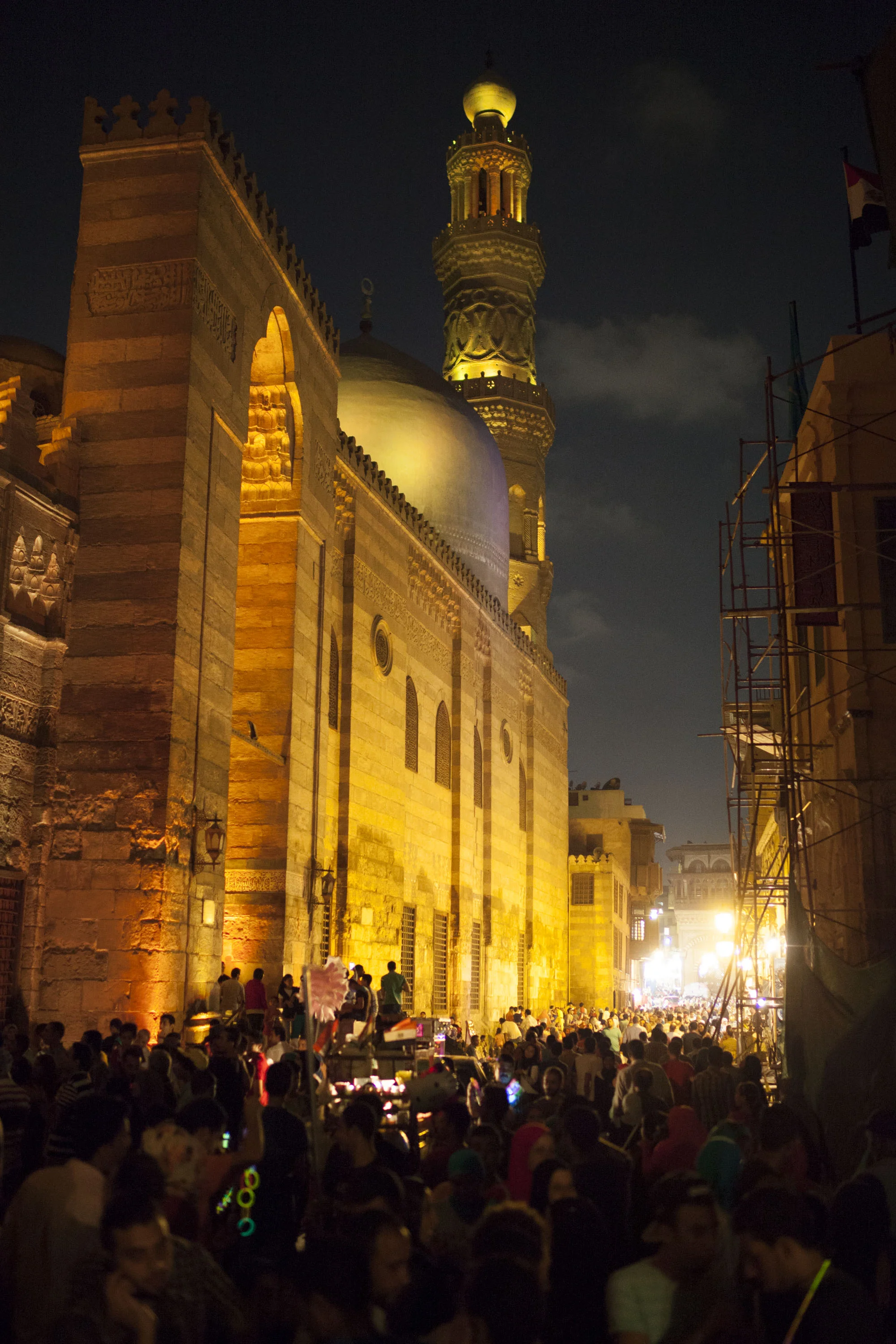 A huge gathering of people outside a mosque. Ramadan = people shopping all night and smoking shisha til 5am.