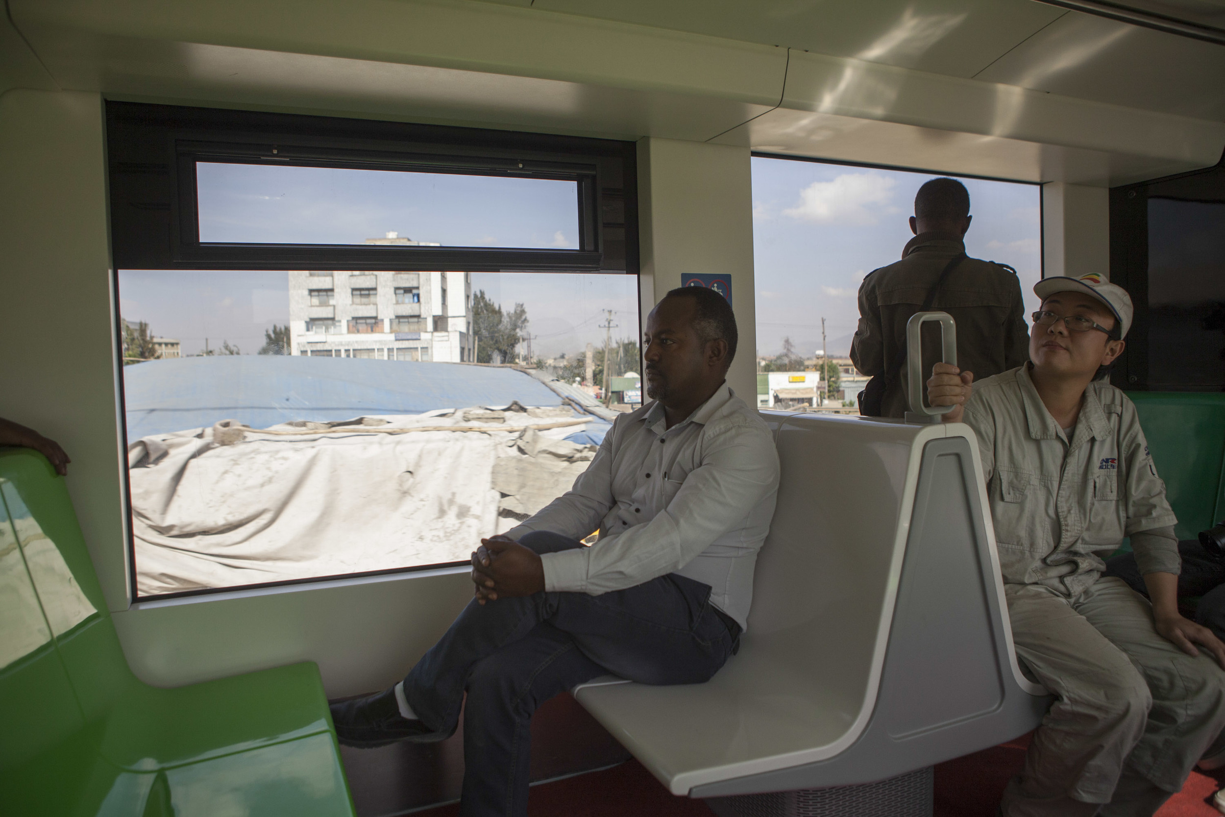  An Ethiopian passenger and Chinese contractor are pictured on a test run of the Addis Ababa lightrail. AFP Photo Zacharias Abubeker 