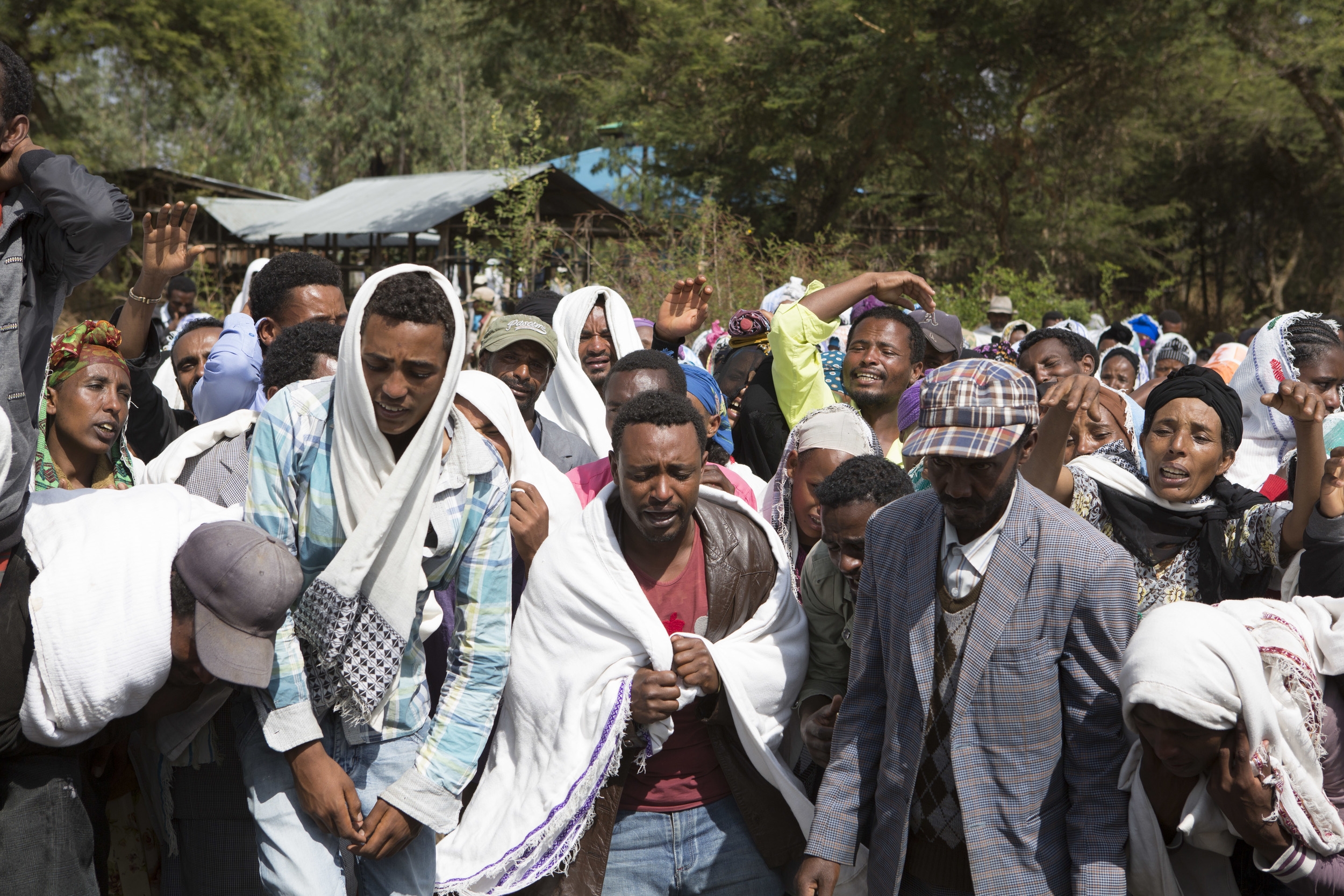  People are pictured mourning the death of Dinka Chala in Yubdo Village, about 100km from Addis Ababa in the Oromia region on 17 Dec 2015. Dinka Chala was shot dead by the Ethiopian Defense the day earlier. He was accused of protesting, but his famil