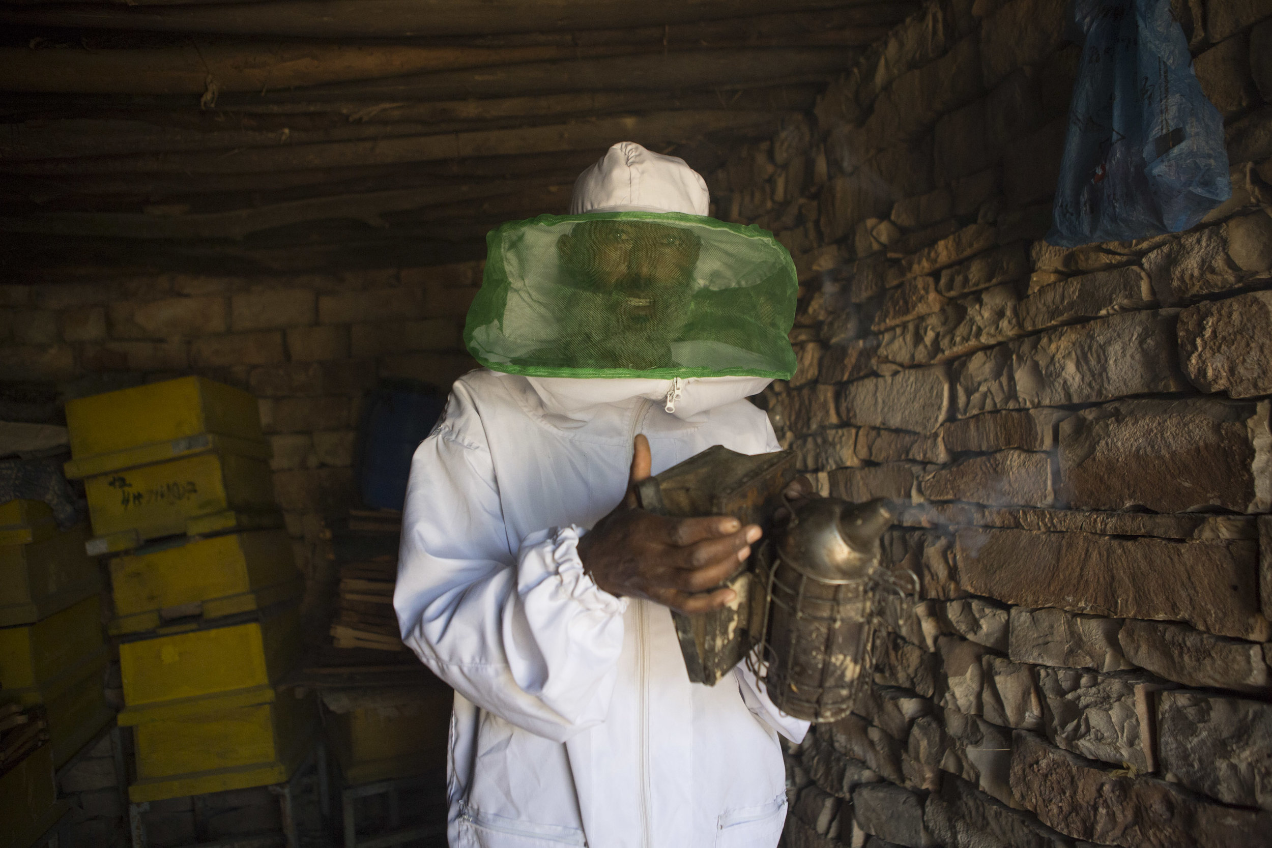  lem Abreha, honey farmer, pictured preparing a beehive smoker on his honey farm outside of Wukro in the Tigray region of northern Ethiopia on 29 March 2017. Abreha has four farms in the locality outside of Wukro, he has had training in different pla