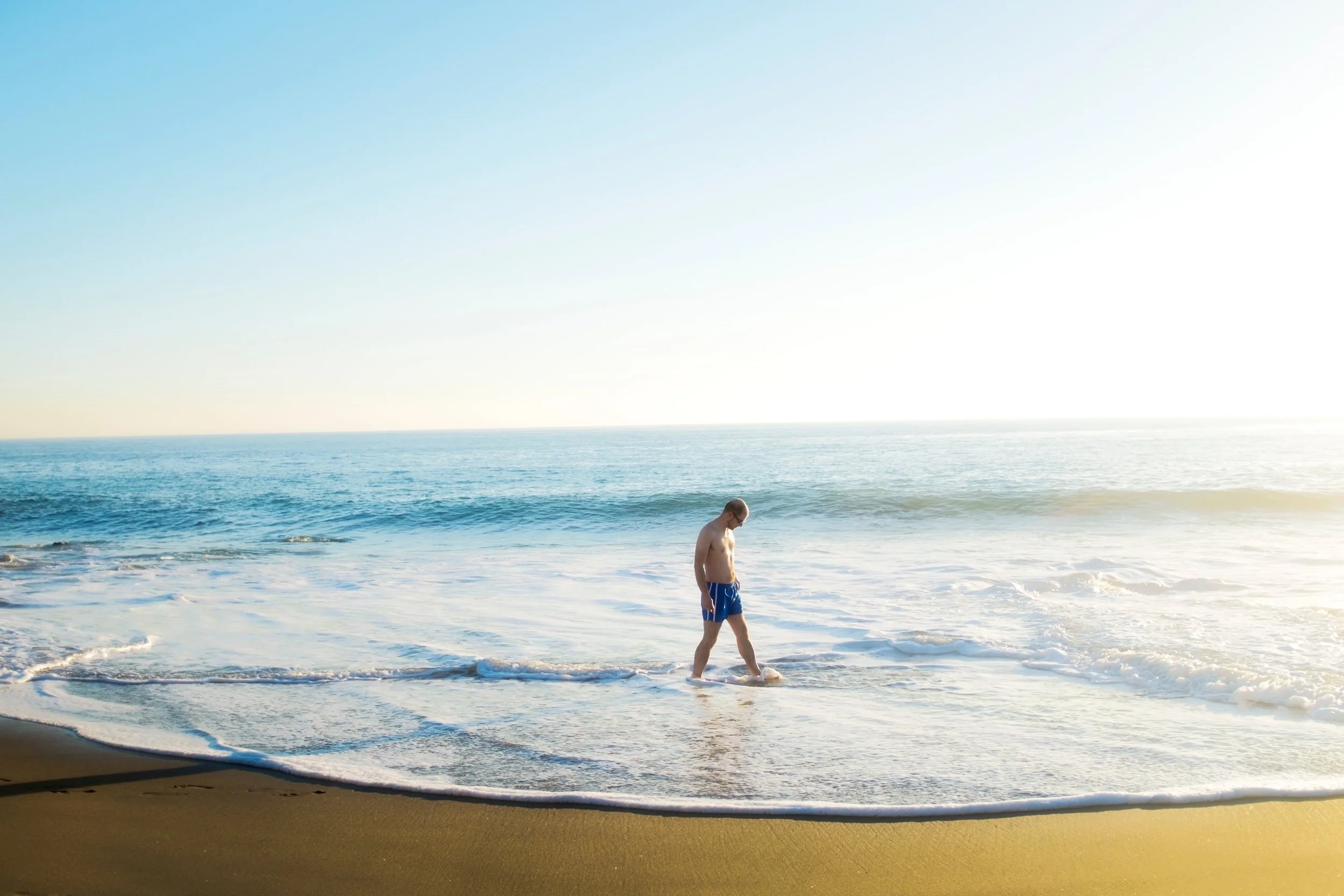 man-walks-aling-leo-carillo-beach-on-a-warm-thanksgiving-day-in-malibu.jpg