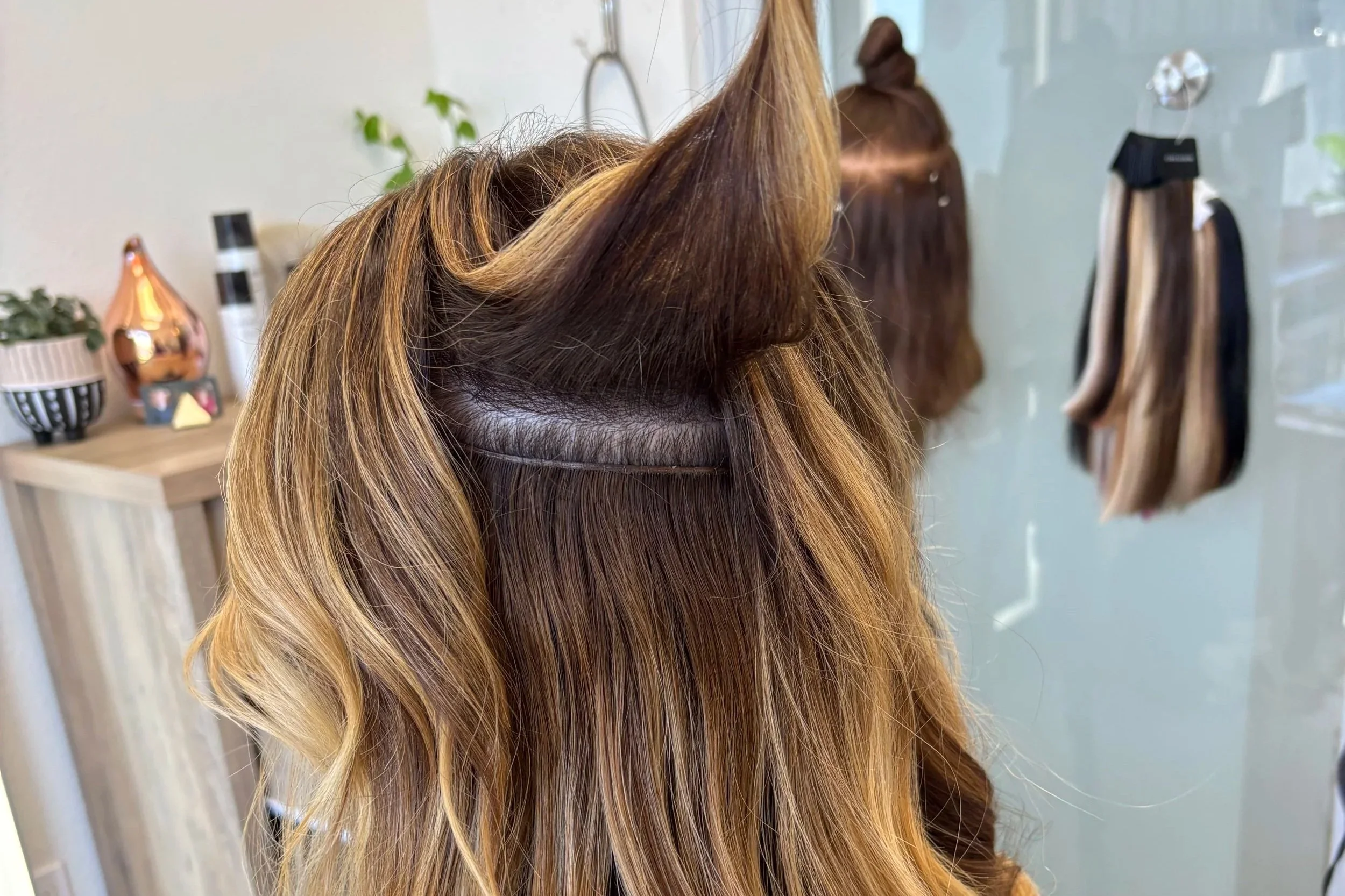 Hidden bead row sectioning technique for hand-tied hair extensions at Kalour Studios, Austin TX