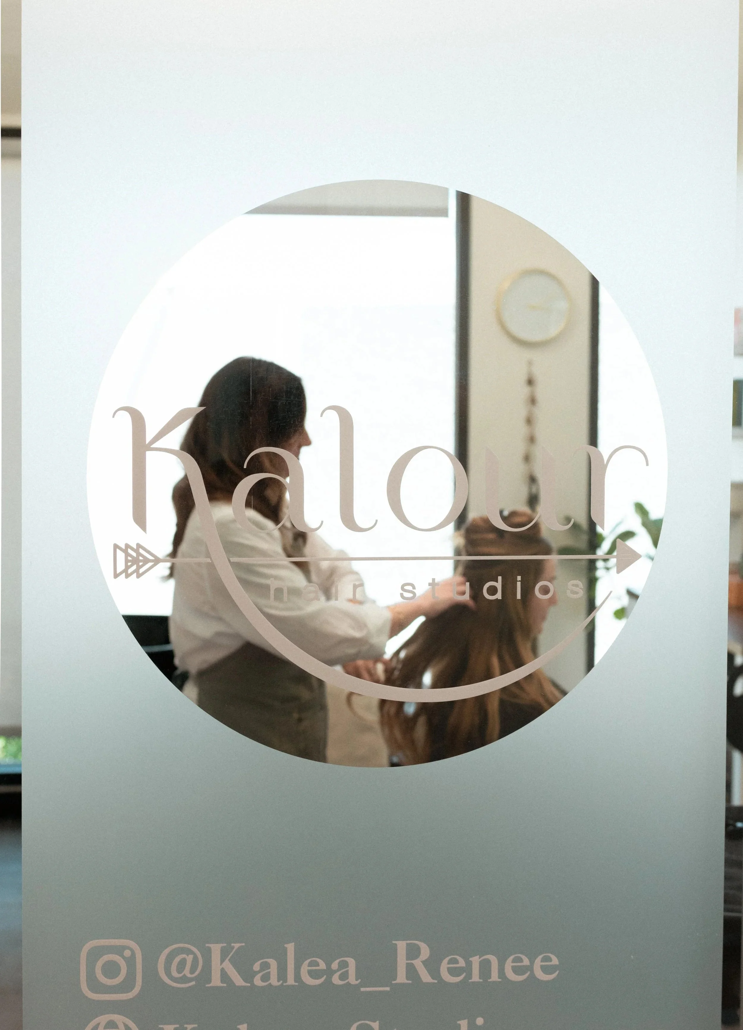 Kalea Renee styling a client's hair extensions at Kalour Hair Studios, Austin TX