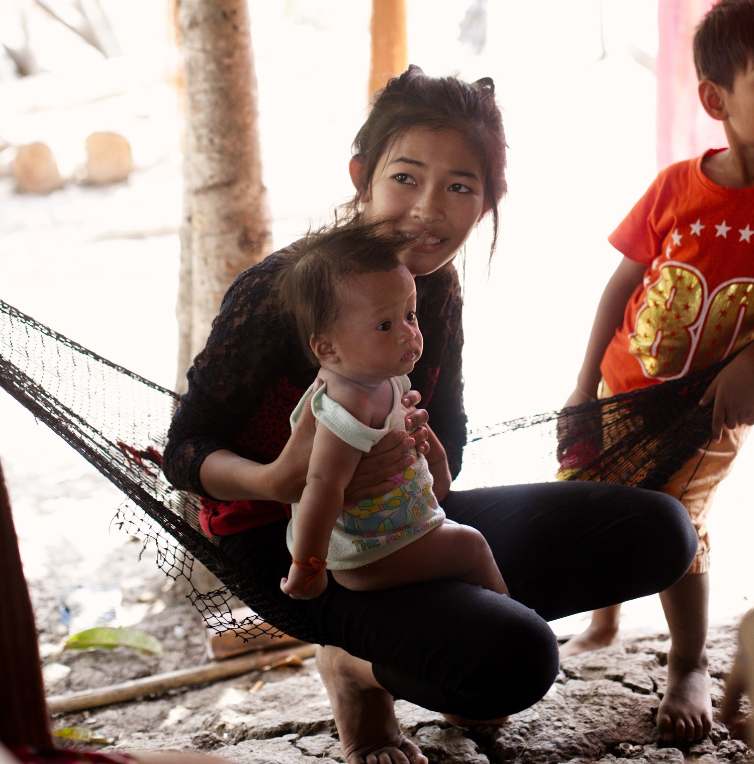 Srey Pich and her new baby in their hut. 