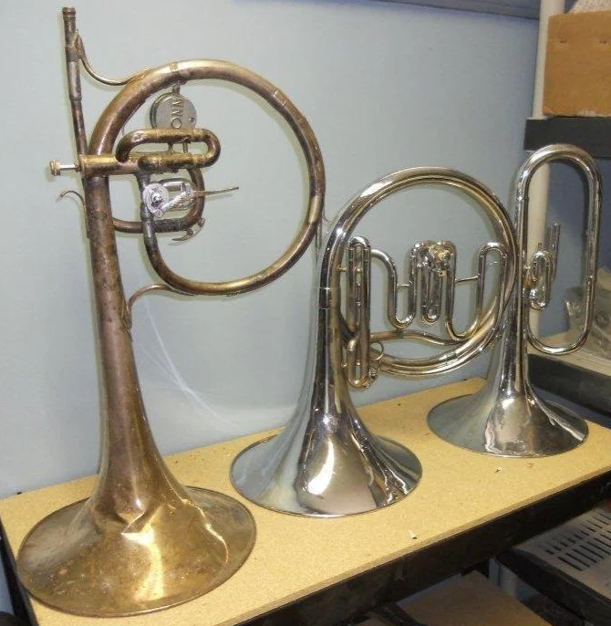 a prototype Conn 16E piston/rotor mellophonium bugle in G (left) for drum corps use