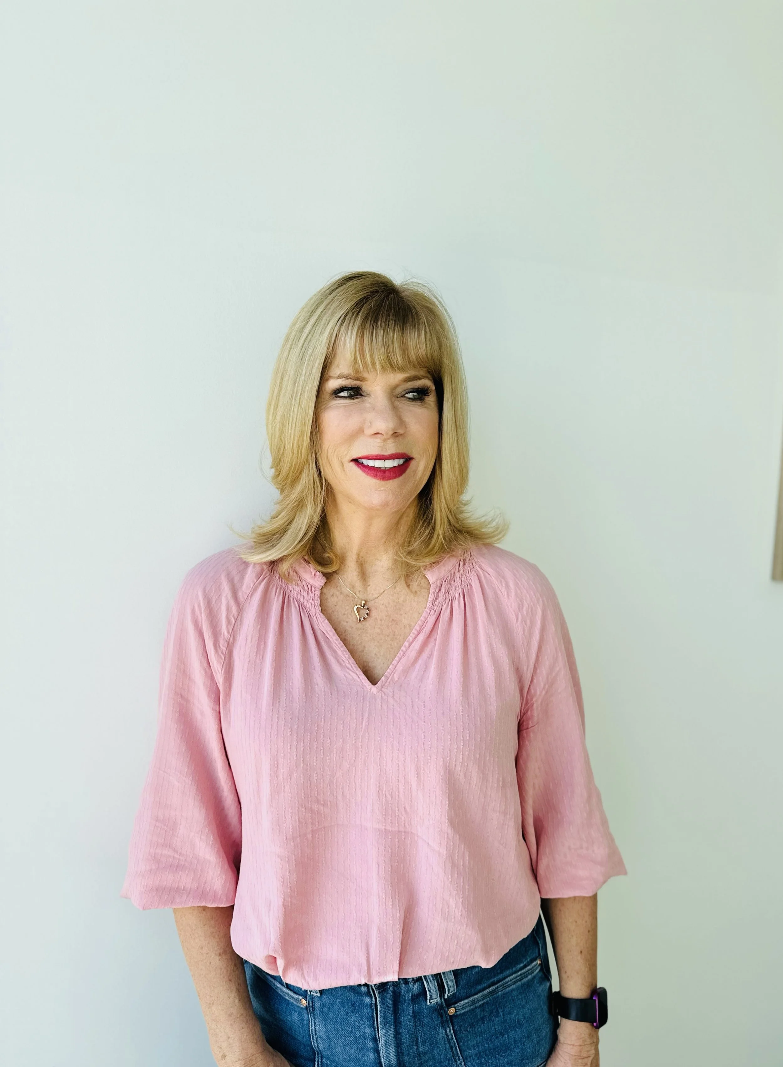Dimensional blonde highlights with long layers and fringe by Evet DeCota at Salon DeCota, San Rafael CA.