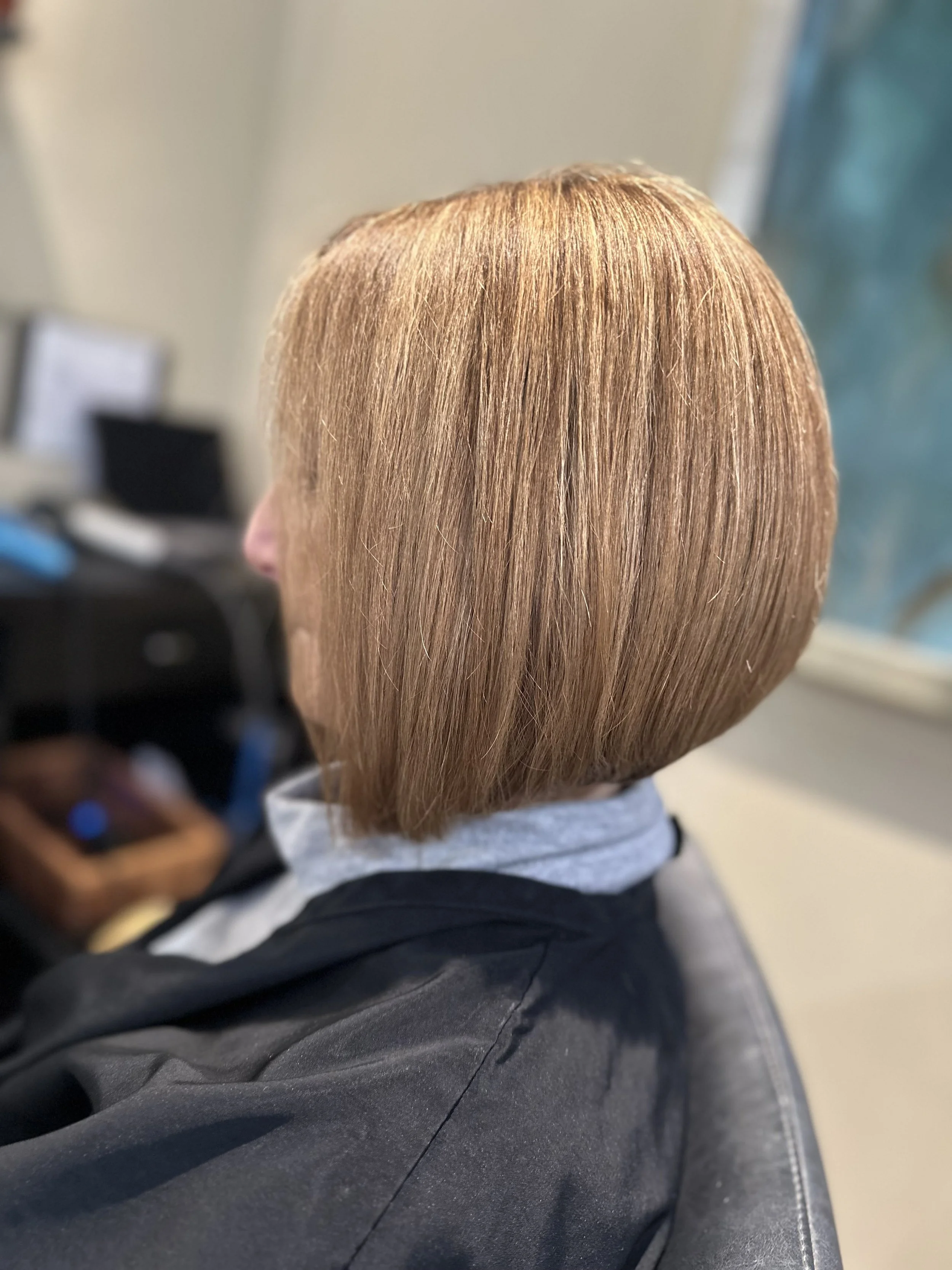 Precision A-line bob with warm golden tone and sleek, polished finish by Evet DeCota at Salon DeCota, San Rafael CA.
