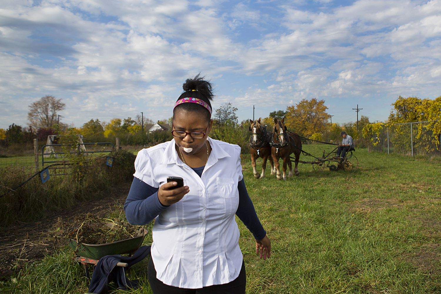 Ajhane Thomas, 18, a student at Catherine Ferguson Academy, walks back to the school barn as Jon Miller of Detroit carefully leads his draft horses, Tess and Tara, around the urban farm for the first time at the school. Miller and his horses plowed through garlic plots on harvest day at the school. Miller hopes that the horses can stable closer to the city to do farm chores and provide educational outings in the city on a regular basis. Catherine Ferguson Academy is a school devoted for young mothers and mothers-to-be in Detroit. Farming Mothers was a club that was established to expose students to agricultural business. There were 200 students enrolled in the school at the time. CFA eventually closed.