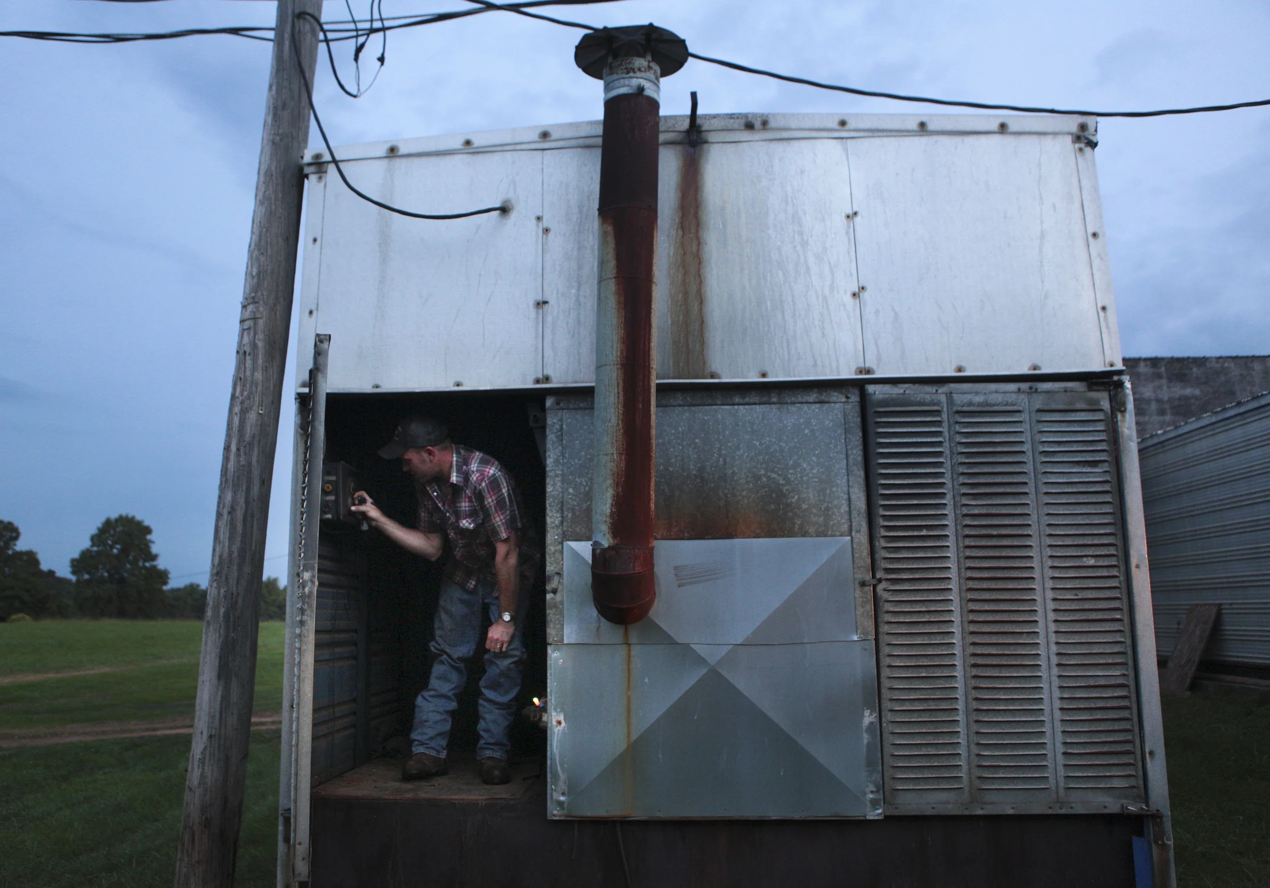 Taylor Ray Amos, 28, checks the curing barns and adjusts the temperatures at the start of the day. 
