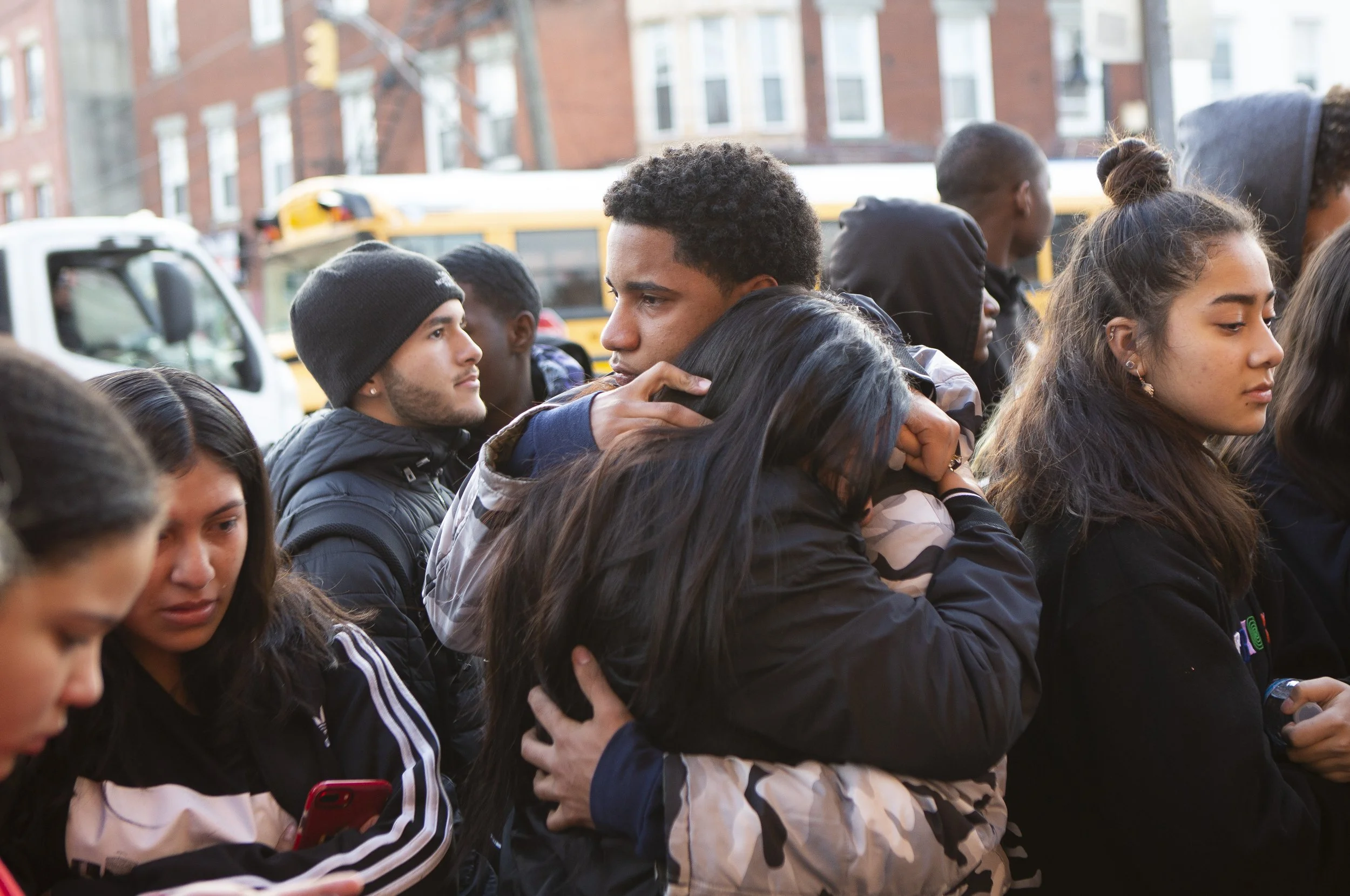  Luis Brioso, 17, hugs a friend at the intersection where Gomez died. “He was like my big brother,” Brioso said, who says he knew him for three years. Brioso said he would go to the barbershop with Gomez to get their hair cut together. Brioso said hi