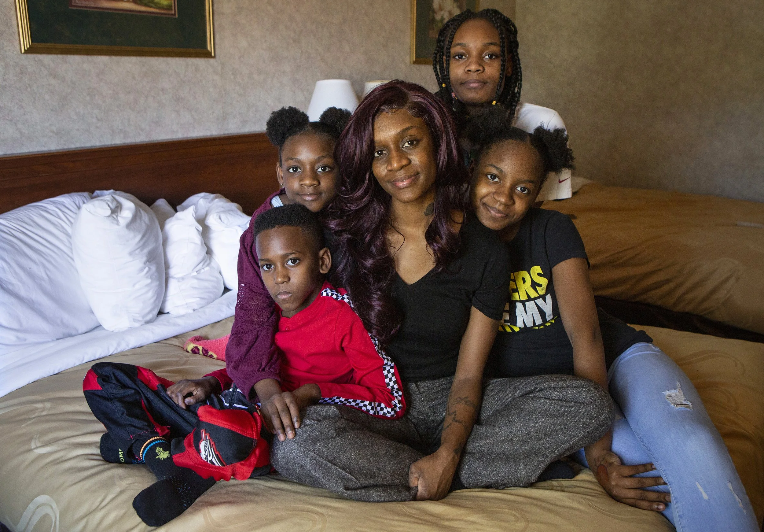  April Goode, 39, sits for a portrait with her children, including (from left) Ethan, 9, Dakota Skye, 10, Jazmyn, 14, and Miriah, 12. Goode and her children have been living at the Quality Inn in Ledgewood, New Jersey for a month now.  