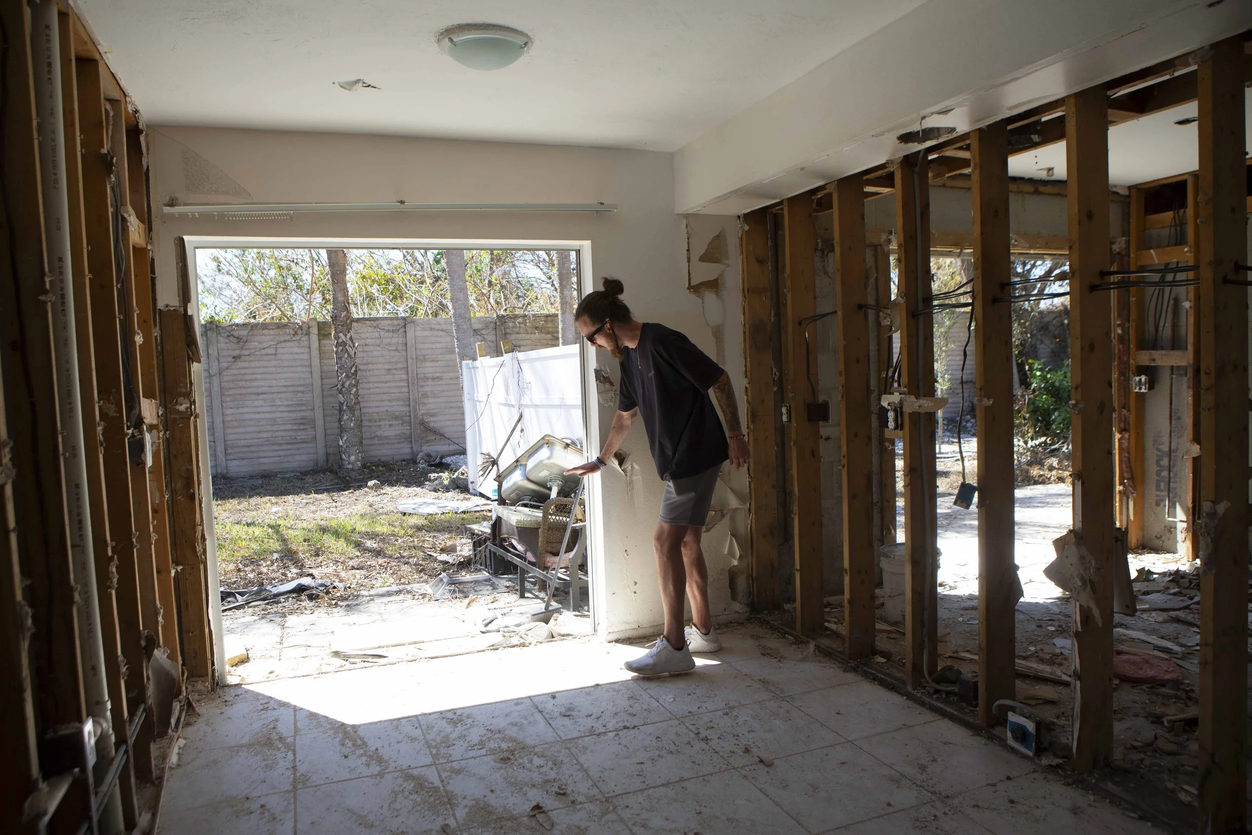  Cole Mazza, 25, shows how high the water reached in his home in the Whitewater Court neighborhood before he decided to leave.  