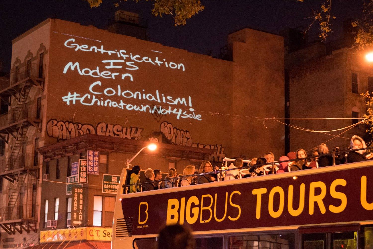  Chinatown Art Brigade’s light projection reading “gentrification is modern colonialism!” 