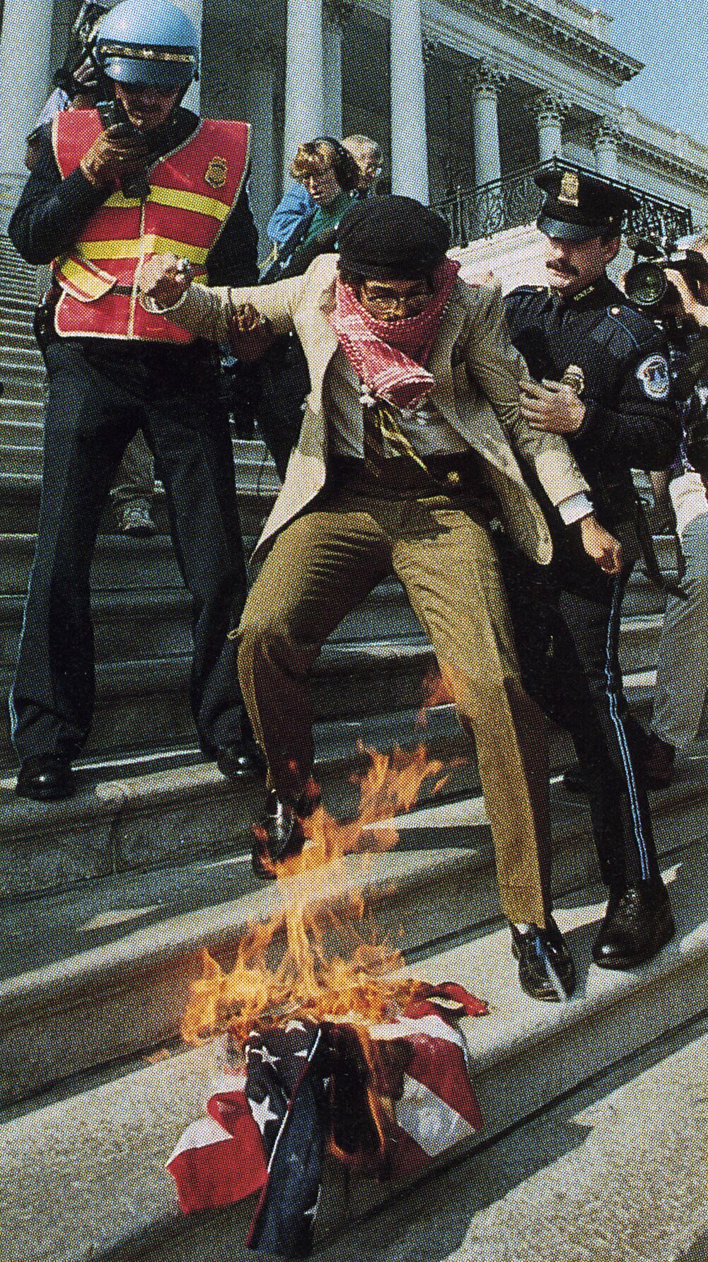 Dread Scott burning the American FLag on the steps of the U.S. Capitol, October 30, 1989, photograph by Charles Tasnadi, AP