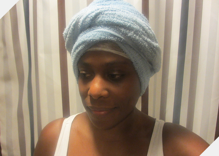 Hair wrapped in cling film and towel