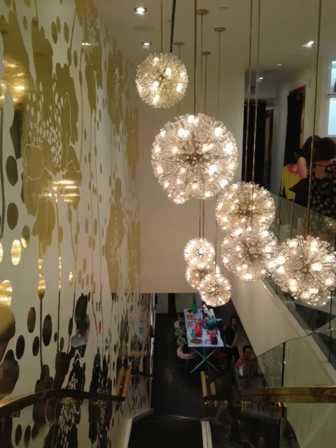 Kate Spade Honolulu. Beautiful Starburst light fixtures and awesome gold foil wall paper.
