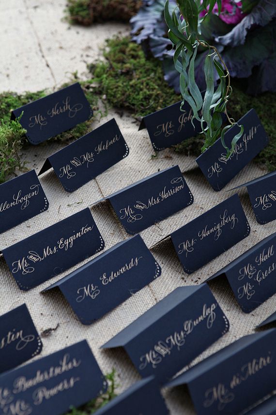 Opt for dark card stock over light and write out guests' names in a gold gel pen. Embellish with simple dot patterns and rounded corner for an added touch. Source
