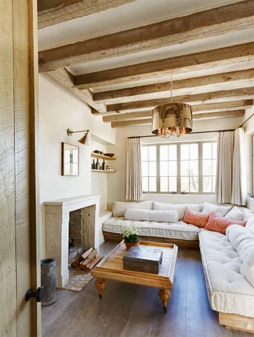 An unexpected, chic light wonderfully compliments this otherwise casual, rustic sunroom.