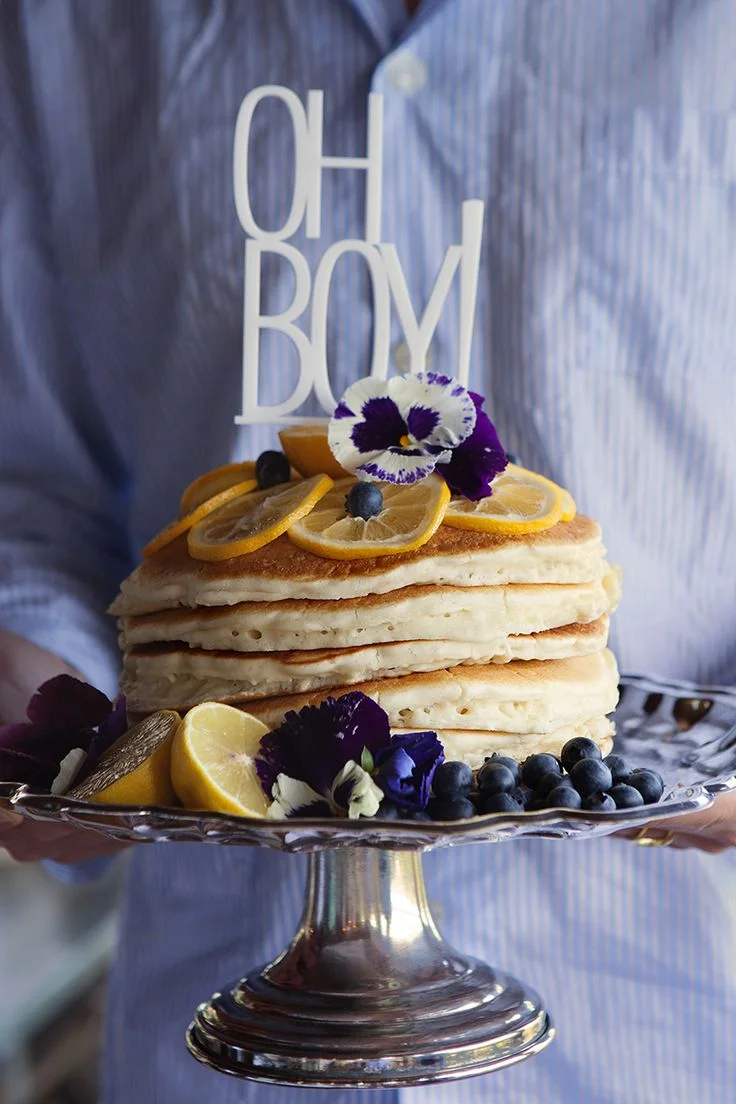 I love the idea of a brunch gathering or shower.  Especially one that involved a pancake "cake" like this one featured on Camille Styles.