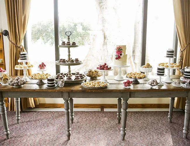 Think small.  Even a small gathering can have a big look if you make everything mini--like these desserts at Desiree Hartsock's wedding shown on Inspired by This.  Think mini cakes, mini banana puddings, macaroons, etc.