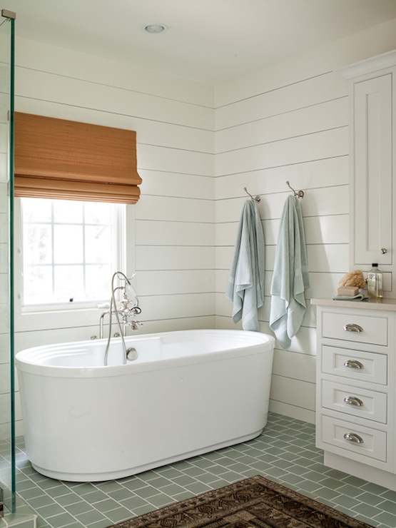 White ship lap in a bathroom designed by Lauren Liess Interiors via DecorPad .