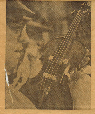 Mr. Zeswtiz puts the finishing touches on a reconditioned violin