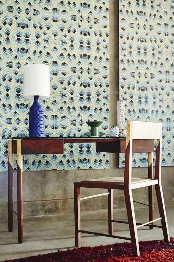 WRITING DESK STYLED IN FRONT OF WOLFUM WALLPAPER.