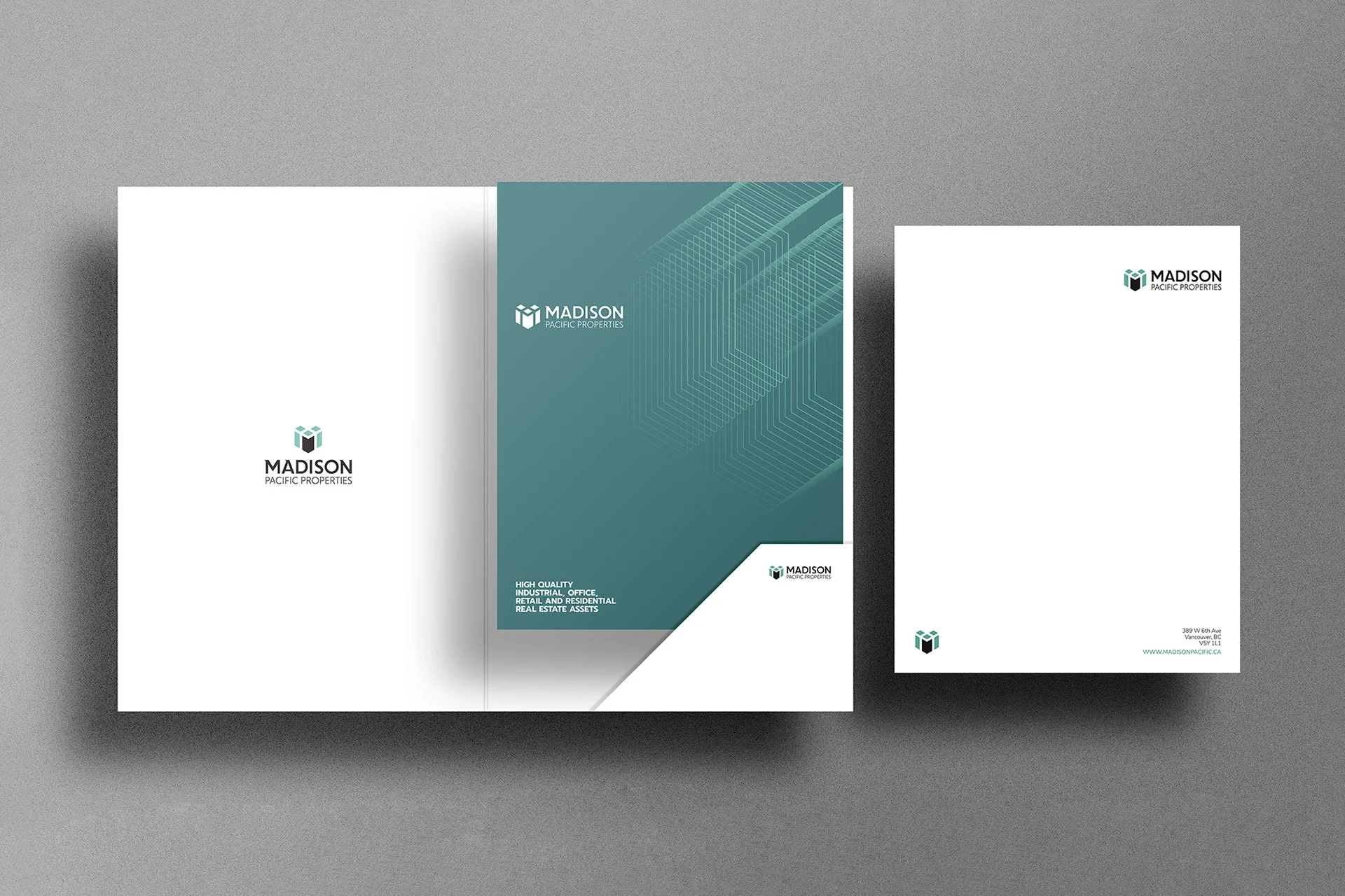 Brochures and flyers for Madison Pacific Properties, featuring modern geometric designs, company logo, and contact information on a gray surface.