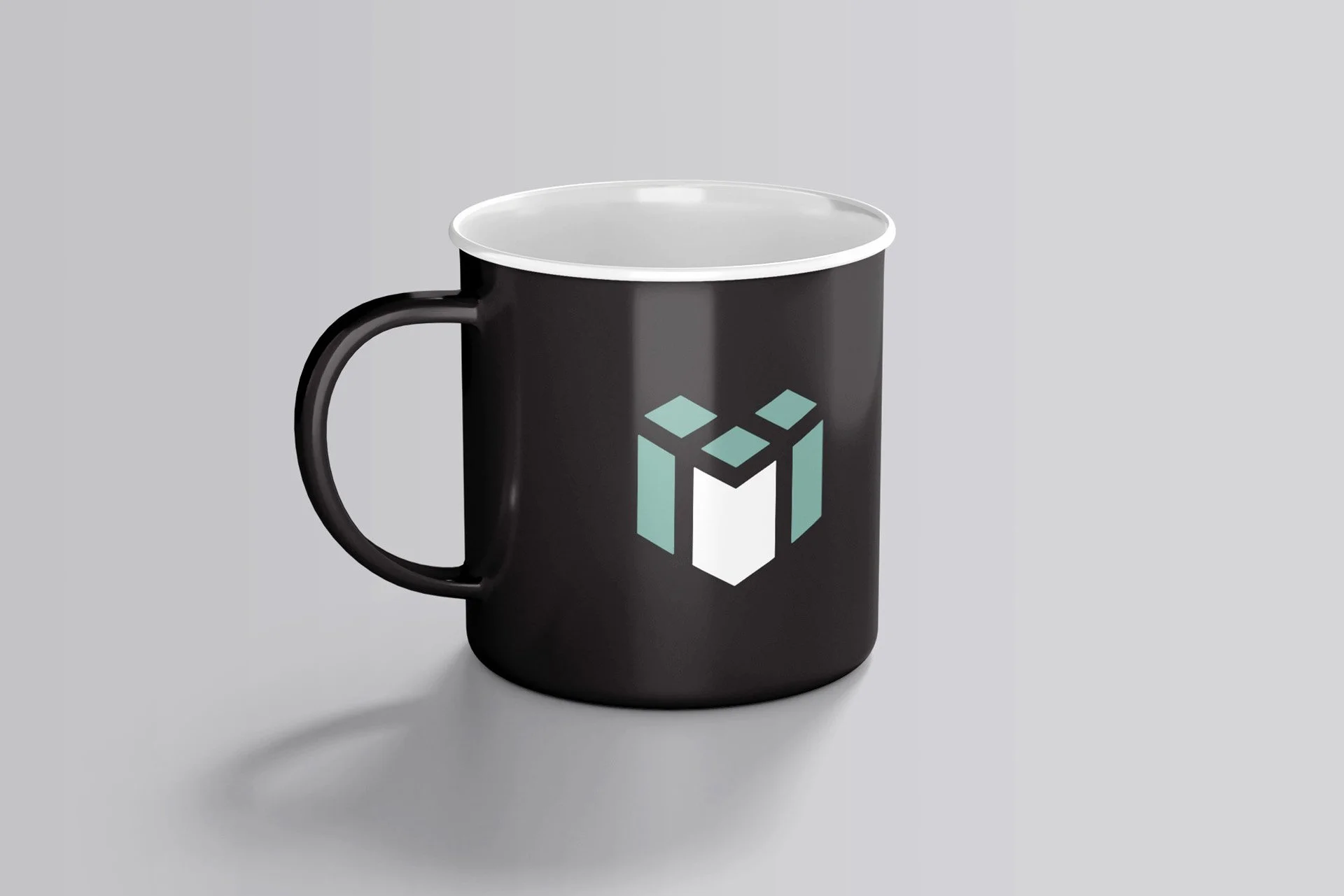 A black mug with a geometric logo design on the side against a light gray background.