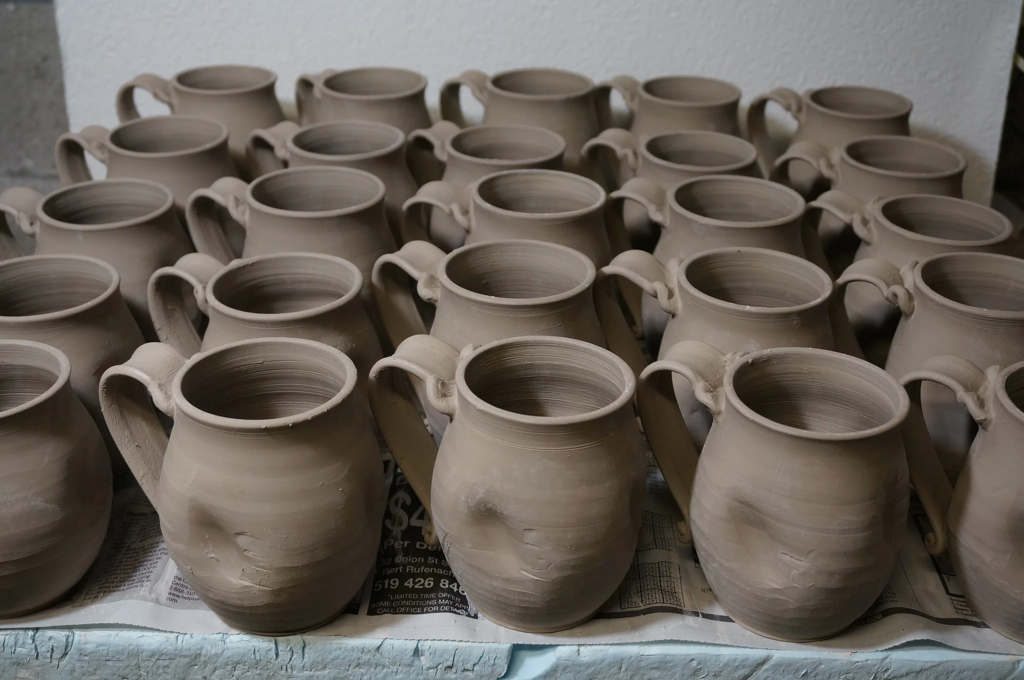 Sanity mugs being dried slowly after attaching the handles. If they dry to quickly, the handles will crack and fall off.