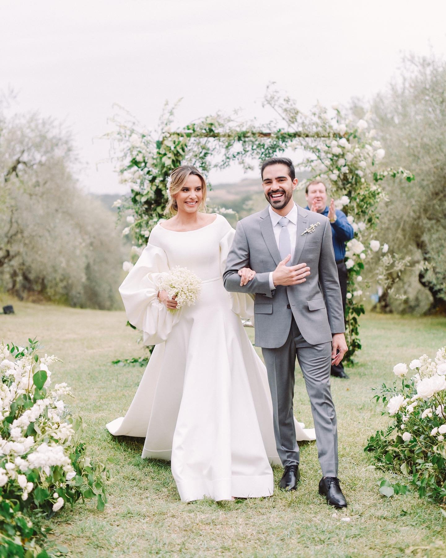Maya and Rafael, deeply in love, walking down the aisle after an emotional outdoor ceremony in the enchanting gardens of @tenuta_corbinaia 

Featured on @constancezahn 

Wp: julianamamed for tuscanyblu 
Venue: @tenuta_corbinaia 
Flowers: @flowerslivi