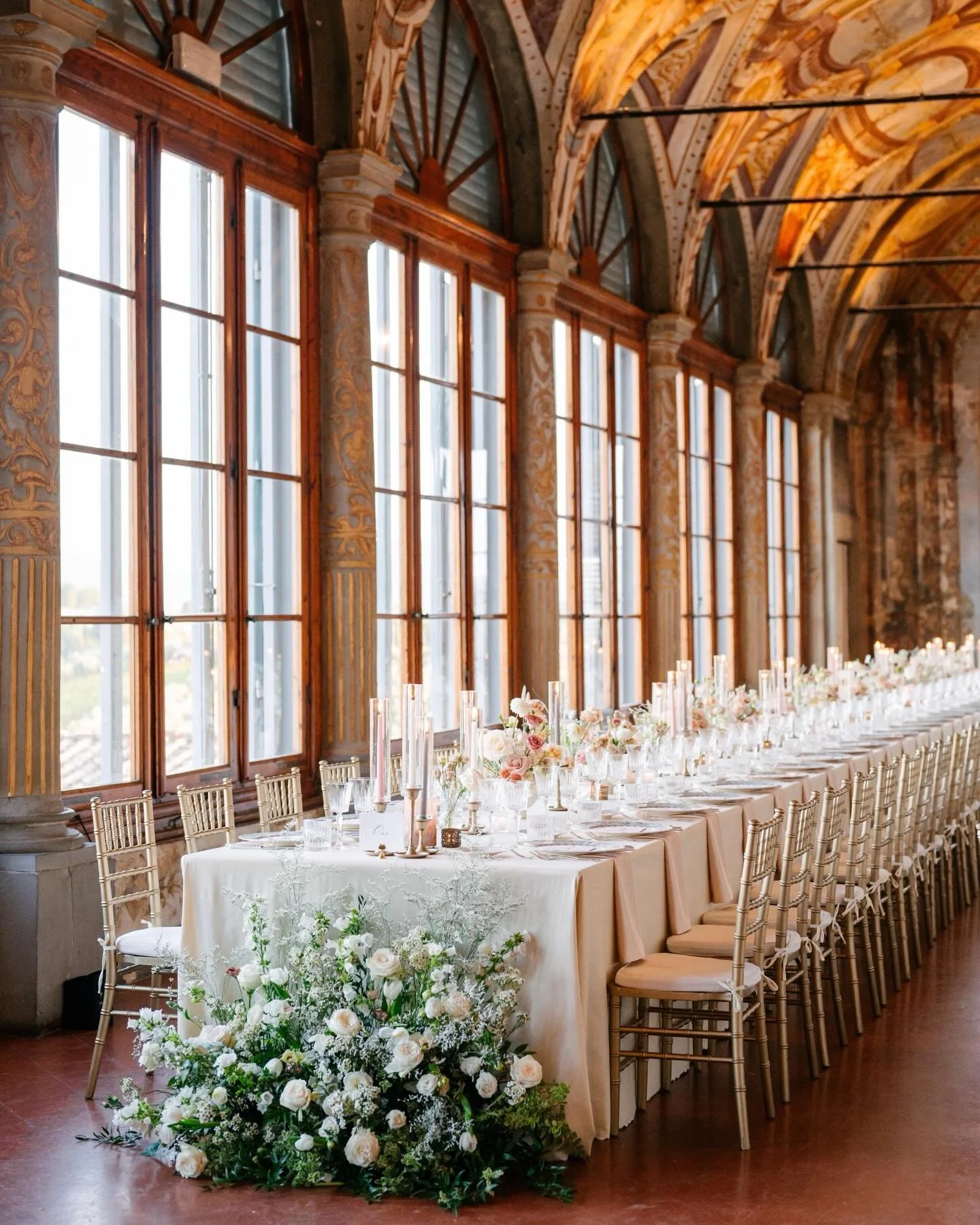 Imperial elegance doubled. A stunning double imperial table set in the frescoed gallery of @villa_corsini , surrounded by candlelit d&eacute;cor and blooming flowers. Luxury event styling at its finest. 

Wp: @originaltuscanwedding 
Photographer: @la