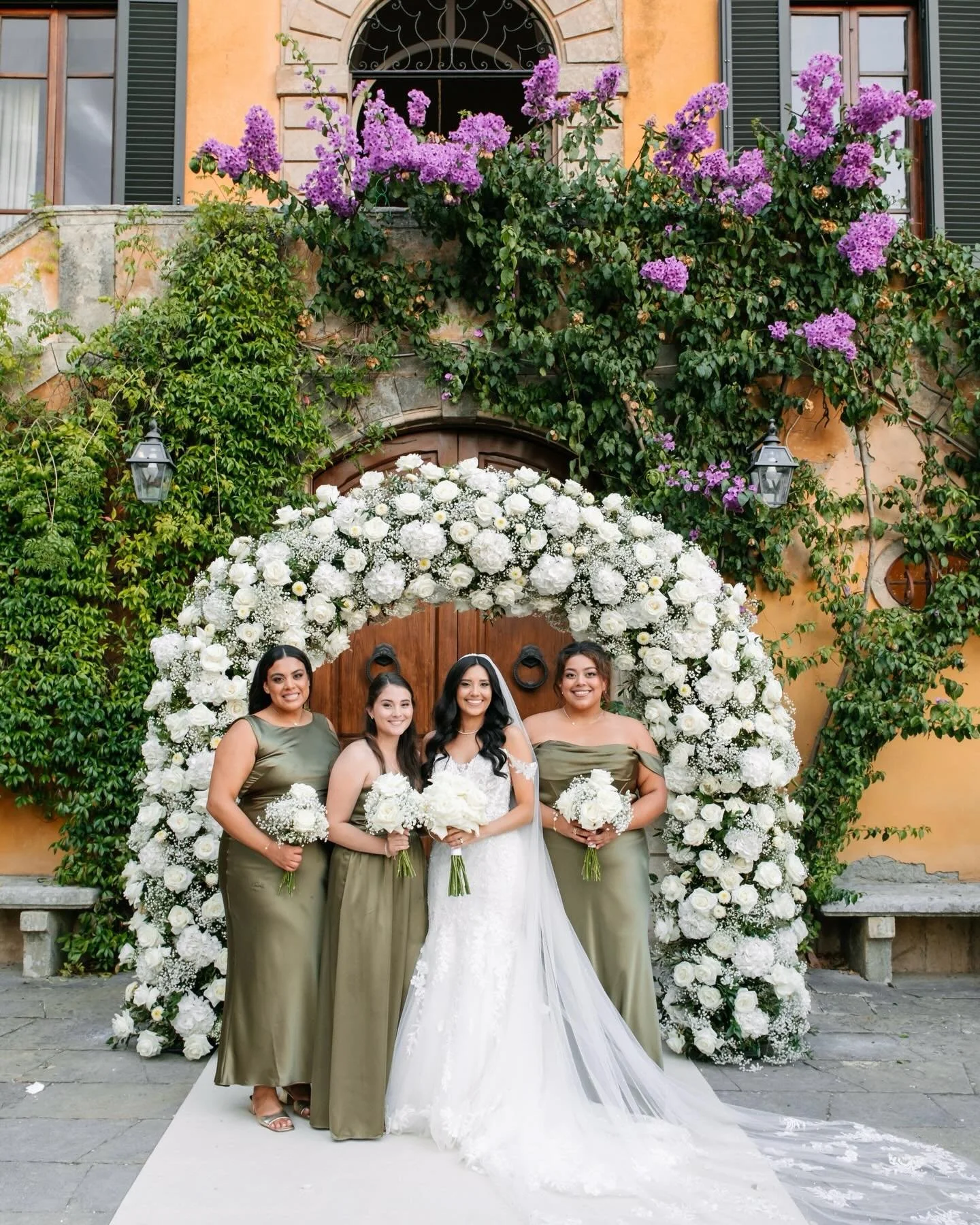 Annette, radiant in white, framed by her bridesmaids in shades of green.

WP and design: @bottegadamore 
Wedding venue: @villa_di_ulignano 
Photo: @landvphotography
Catering: @rolands_florence 
Flowers: @flowersliving 
Music: @whiteband_whiteband 
Mu