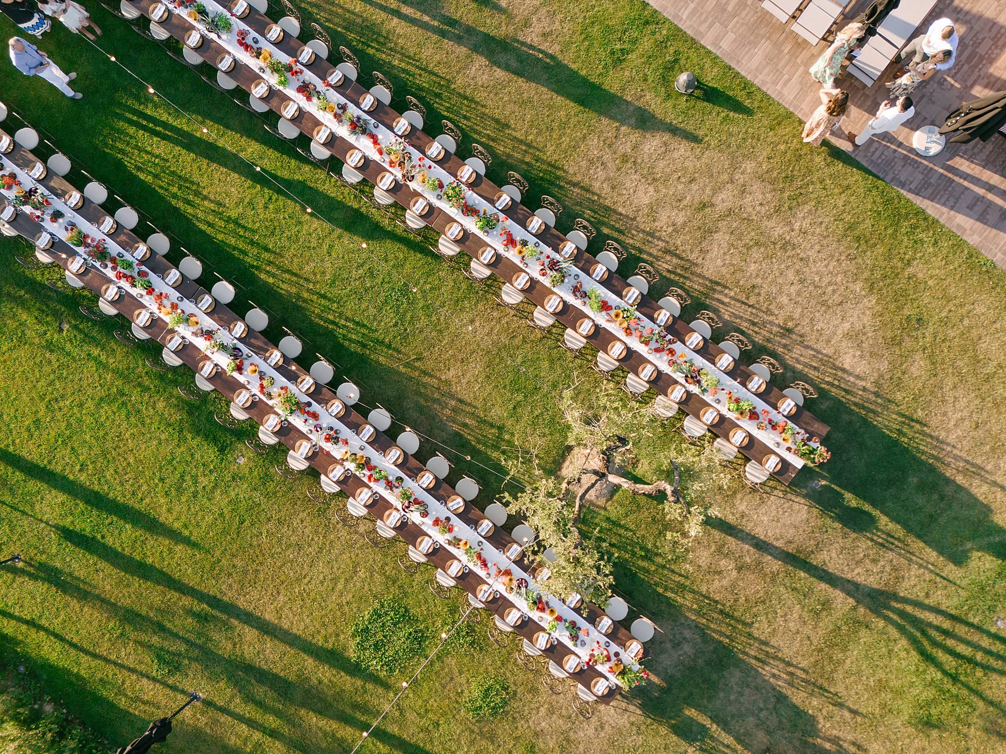 Aerial shot of a destination wedding welcome party, chic rustic tables