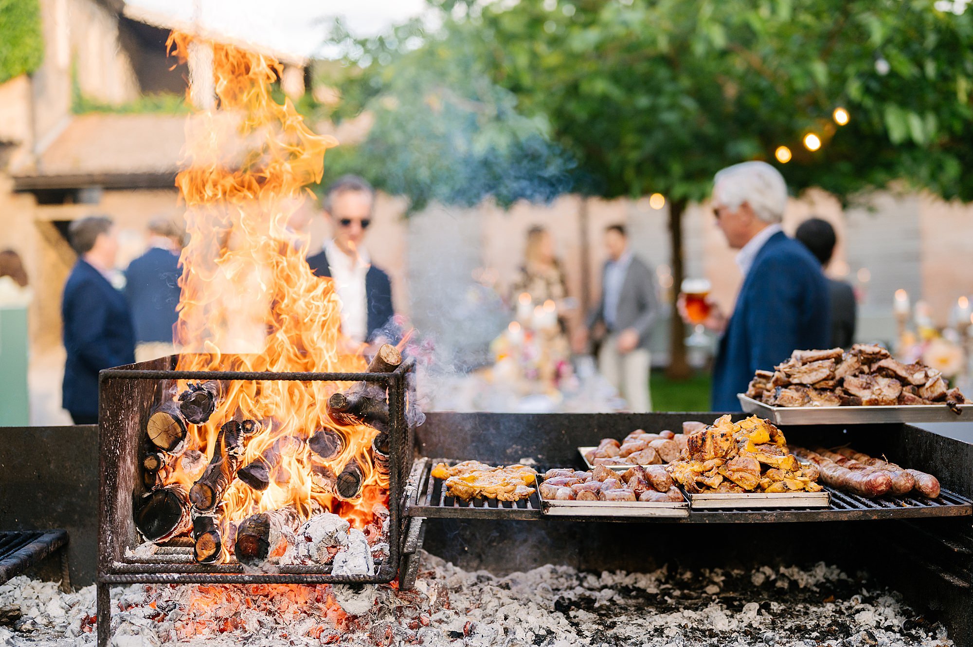 Candid wedding welcome party photography in Italy, guests enjoying barbecue